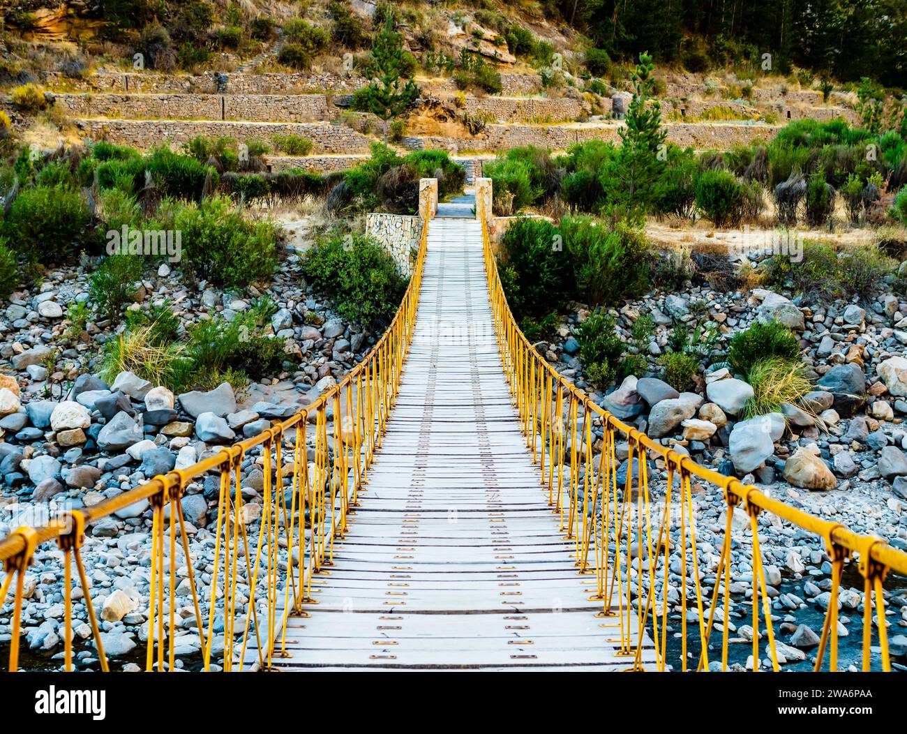 Rope bridge and mountain and river hi-res stock photography and