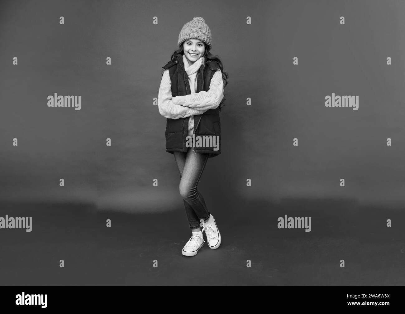 female fashion model. teen girl in down vest. full length of child