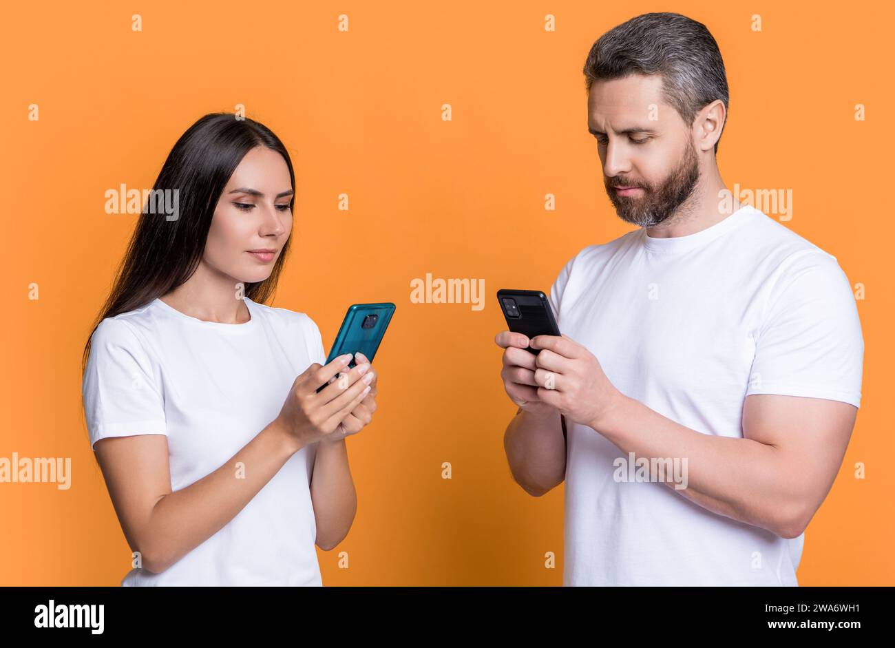 Texting Through Phone Couple texting using cellphones in hi-res stock photography and images ...