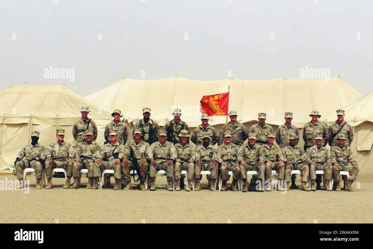 US military forces. US Marine Corps (USMC) Marines of the 1st Battalion, 5th Marines (1/5) pose for a group shot at a forward deployed location during Operation IRAQI FREEDOM. All are US Marines except as noted.  Front Row (Left to Right): Headquarters & Service Company (H&S CO) Captain (CPT) Wil Dickens, Weapons Company (CO) CPT Pete Faruum, C CO CPT Shawn Blodgett, B CO CPT Jason Smith, A CO CPT Blair Sokol, Operations (OPS) Master Gunnery Sergeant (MGYSGT) Herman Medina, Operations Section (S3) Major (MAJ) Steve Armes, Executive Officer (XO) MAJ Cal Worth, Commanding Officer (CO) Lieutenant Stock Photo