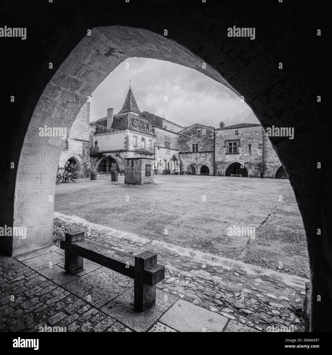 Black and white image of the market square in the 13th century bastide of Monpazier in the Dordogne region of France Stock Photo