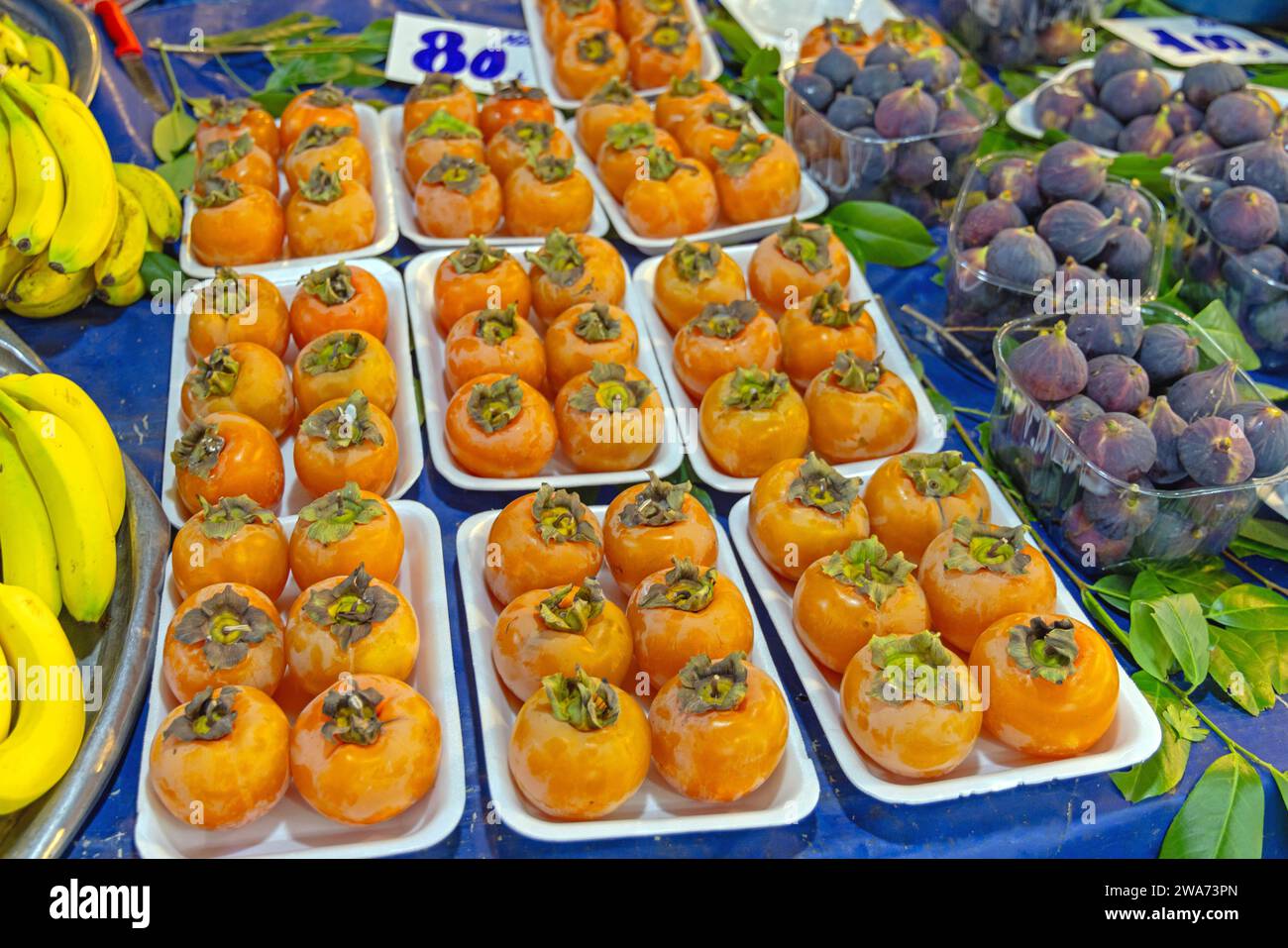Oriental Persimmon Kaki Fuyu Apple Fruits at Trays Stock Photo
