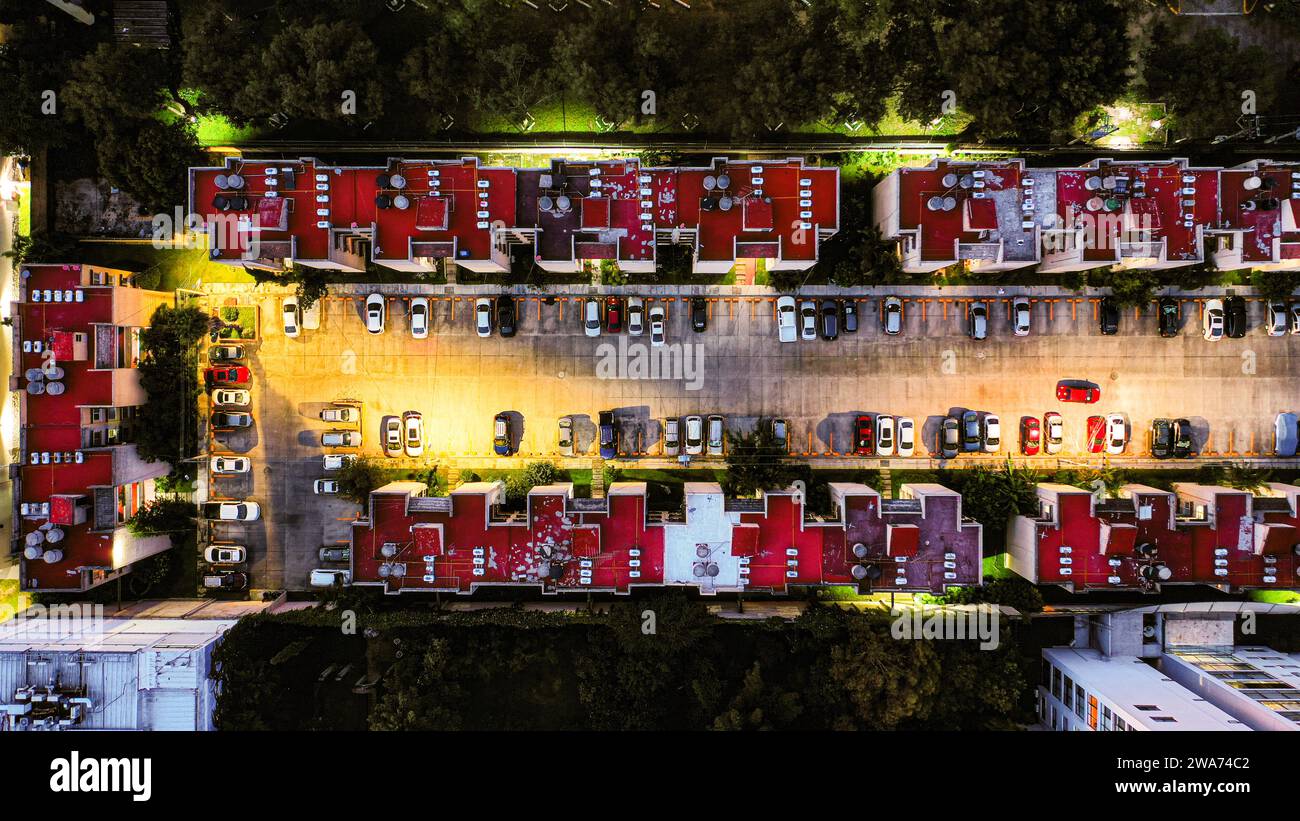 Topdown view of a condominium with parking lot at night Stock Photo