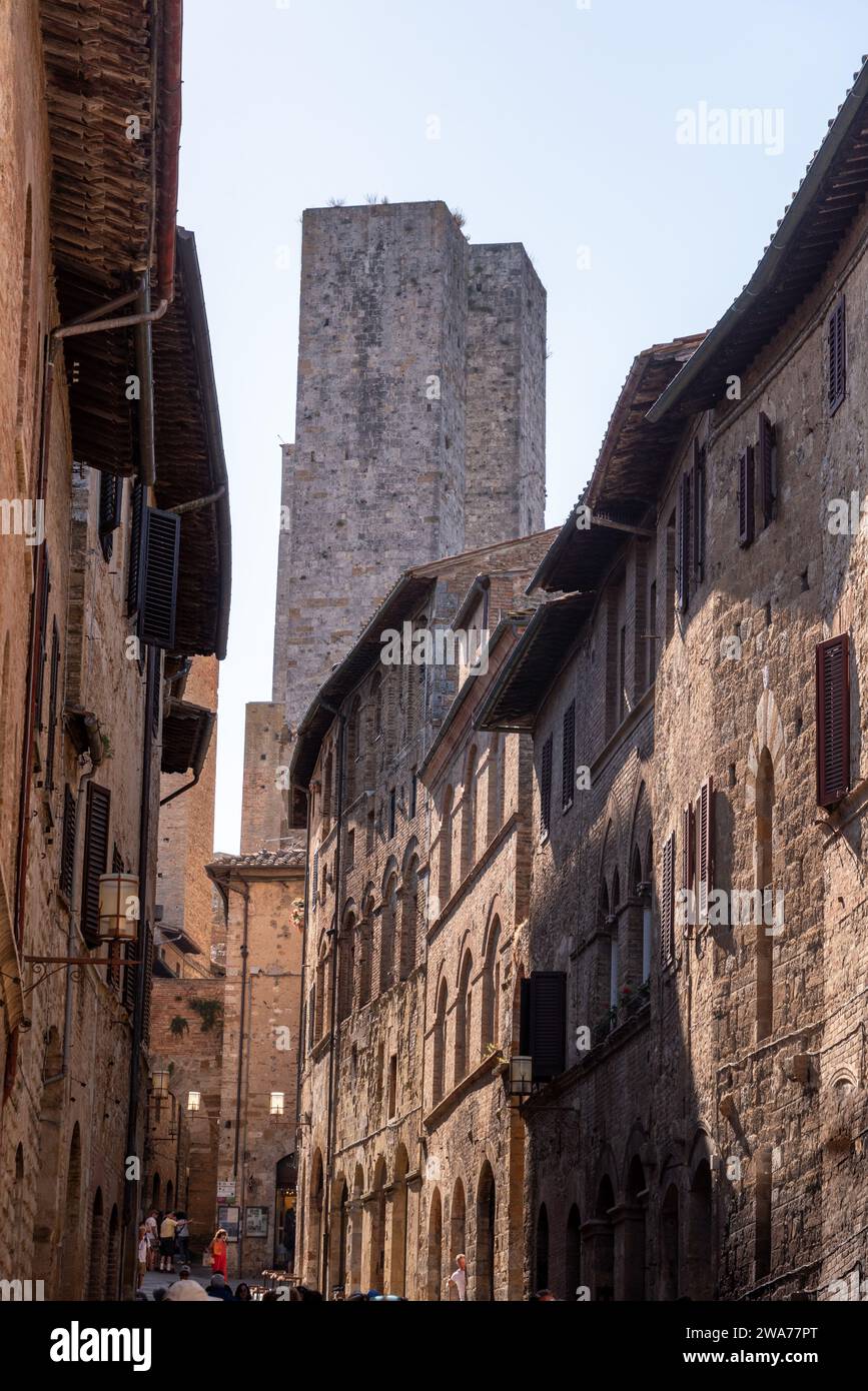 In the streets of San Gimignano, view on the towers Salvucci, Pettini and Chigi - Italy Stock Photo