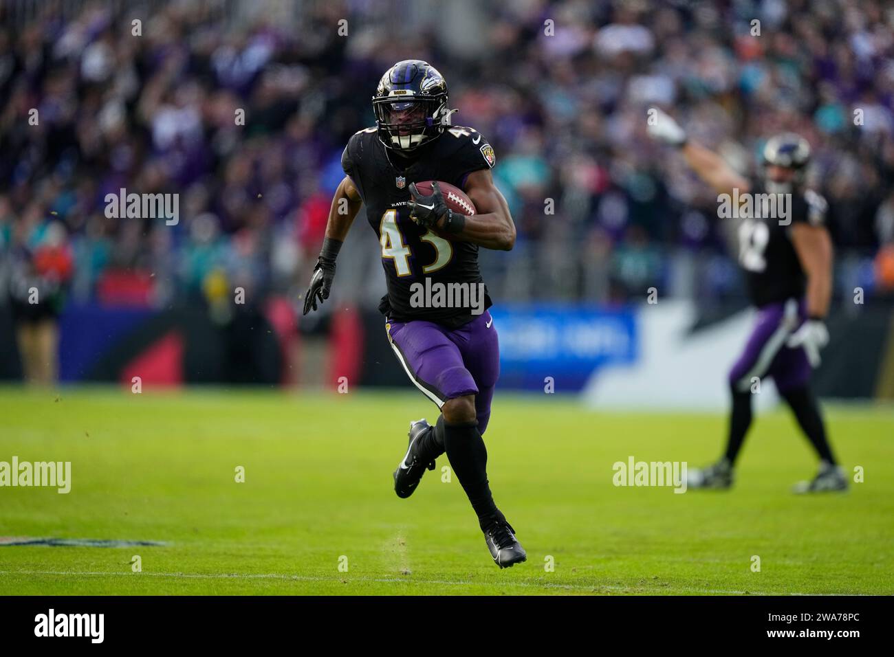  Baltimore Ravens' Justice Hill in action during an NFL football game Illustration 