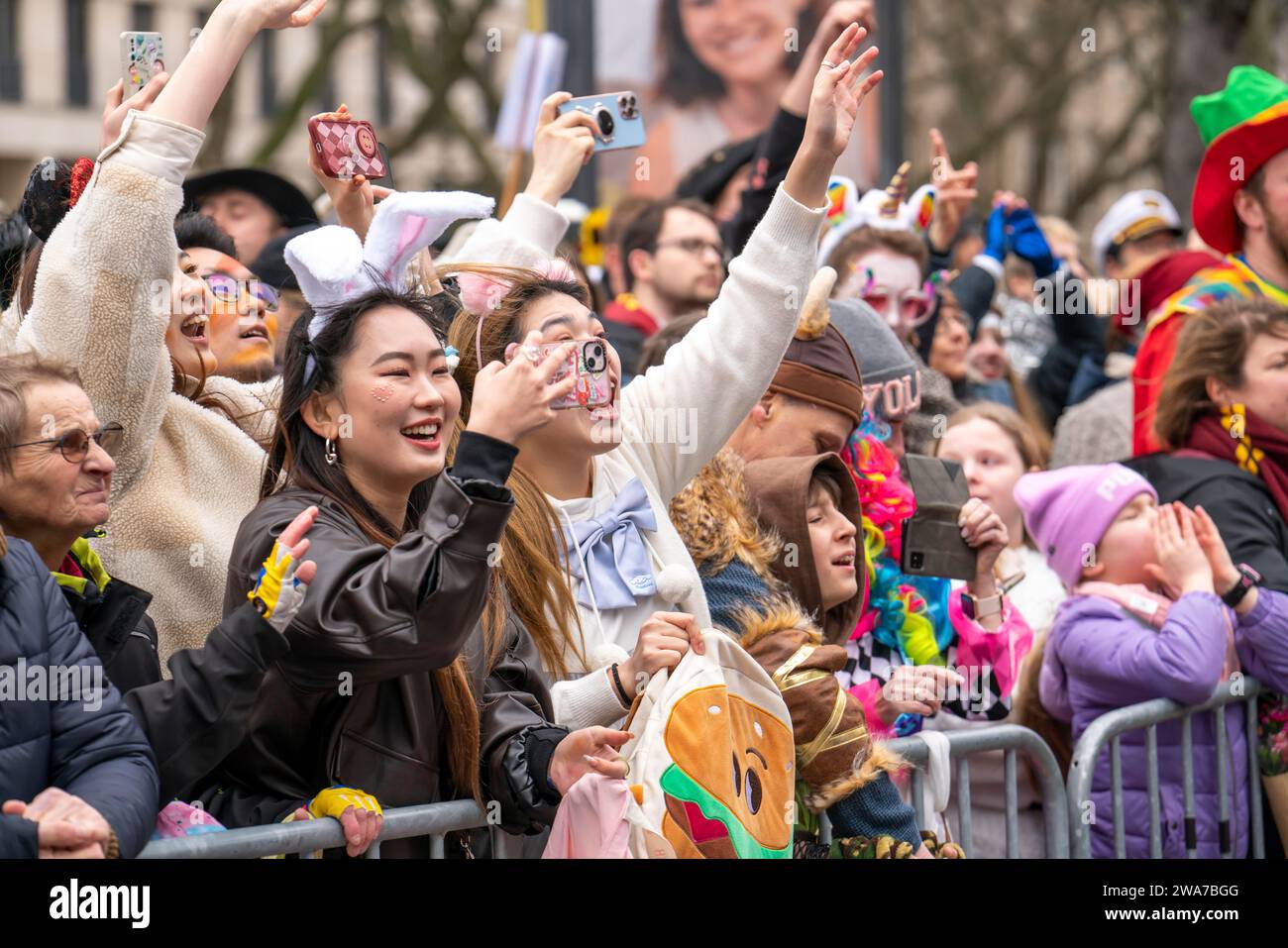 Rose Monday parade in Düsseldorf, Asian spectators, at the street carnival, NRW, Germany Stock Photo