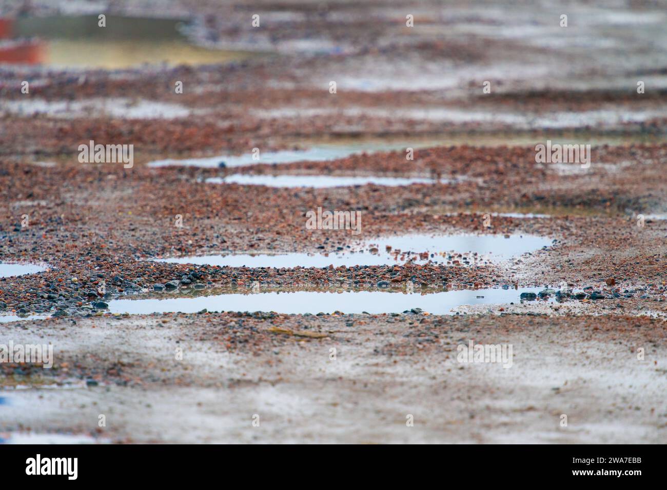 Pot holes on a gravel parking space Stock Photo - Alamy