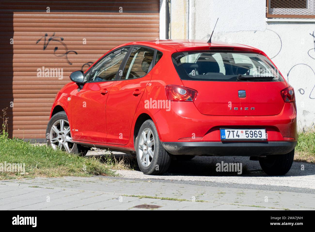HAVIROV, CZECH REPUBLIC - AUGUST 24, 2023: Red Seat Ibiza hatchback car parked in front of a garage Stock Photo