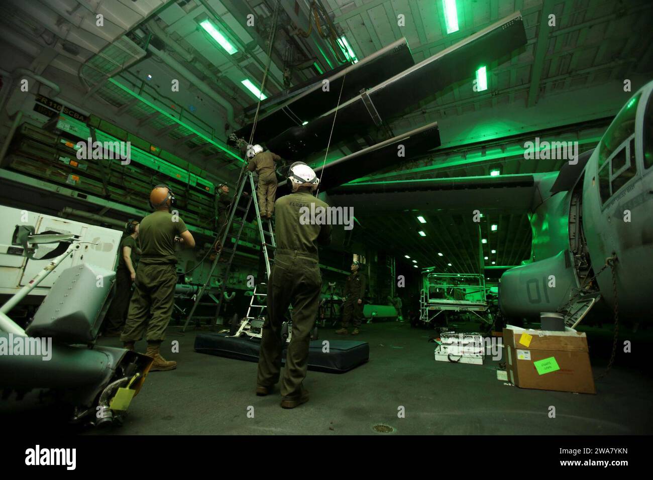 US military forces. 160810AF202-003 MEDITERRANEAN SEA (Aug. 10, 2016) Marines assigned to Marine Medium Tiltrotor Squadron 264 (Reinforced), 22nd Marine Expeditionary Unit (MEU), conduct maintenance on an MV-22B Osprey aboard the amphibious assault ship USS Wasp (LHD 1) on Aug. 10, 2016. 22nd MEU, deployed with the Wasp Amphibious Ready Group, is conducting naval operations in the 6th Fleet area of operations in support of U.S. national security interests in Europe and Africa. (U.S. Marine Corps photo by Lance Cpl. Koby I. Saunders/Released) Stock Photo