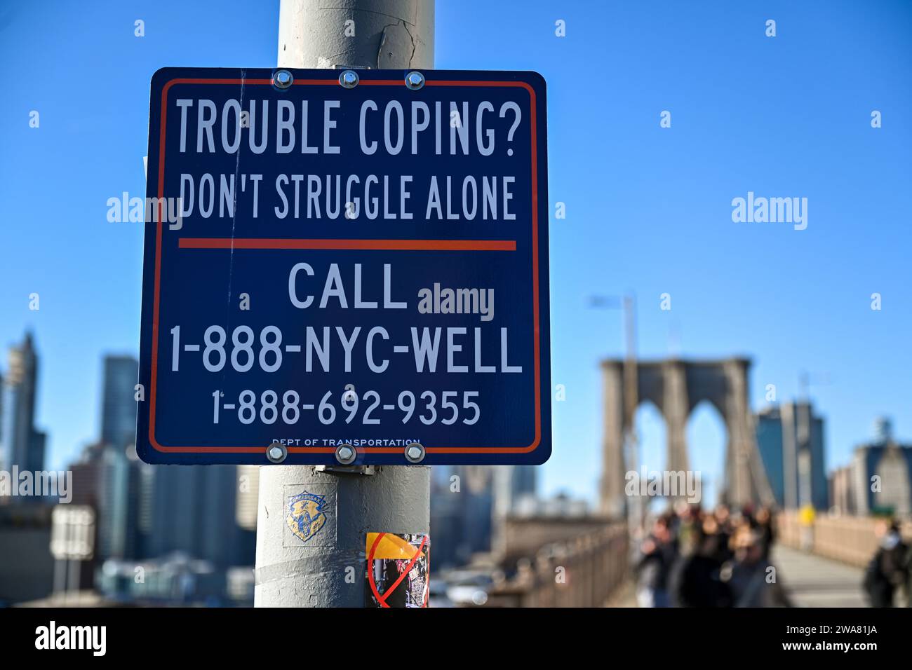 A suicide prevention sign posted on the Brooklyn Bridge pedestrian pathway on January 02, 2023 in New York City. . Stock Photo