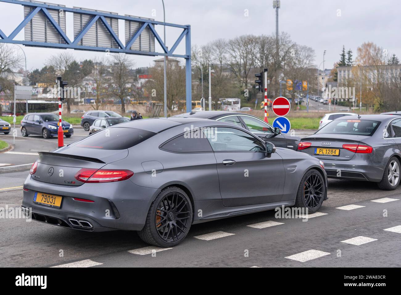 Luxembourg City, Luxembourg - Matte grey Mercedes-AMG C63 S Coupé driving in a street in the middle of traffic. Stock Photo