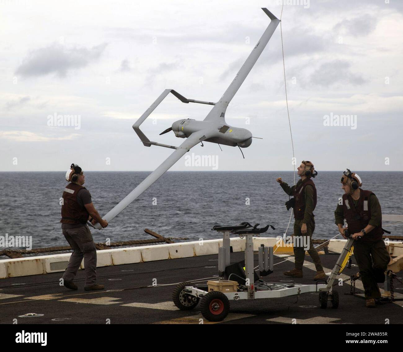 US military forces. Marines with Marine Medium Tiltrotor Squadron 365 Reinforced lower an RQ-21A Blackjack unmanned aerial surveillance aircraft down from the STUAS recovery system using the vertical capture rope as the 24th Marine Expeditionary Unit and USS Mesa Verde (LPD 19), wrap up a simulated straight transit to rehearse a defense of the amphibious task force mission during Amphibious Ready Group Marine Expeditionary Unit Exercise Dec. 13, 2016. During the three-week training evolution, Marines will tackle a wide range of operations and scenarios enhancing interoperability and amphibious Stock Photo