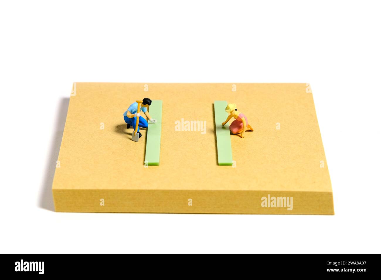 Creative miniature people toy figure photography. Sticky notes installation. A couple doing gardening activity at yard on summer holiday. Isolated on Stock Photo
