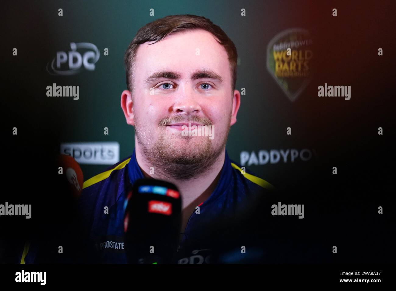 Luke Littler speaks to the media after defeating Rob Cross (not pictured) on day fifteen of the