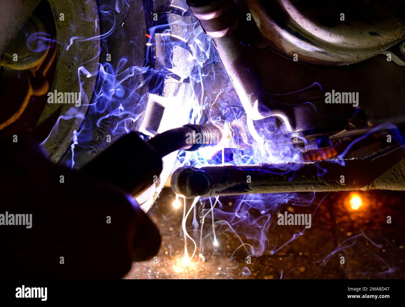 Argon welding to the motorcycle underside Stock Photo