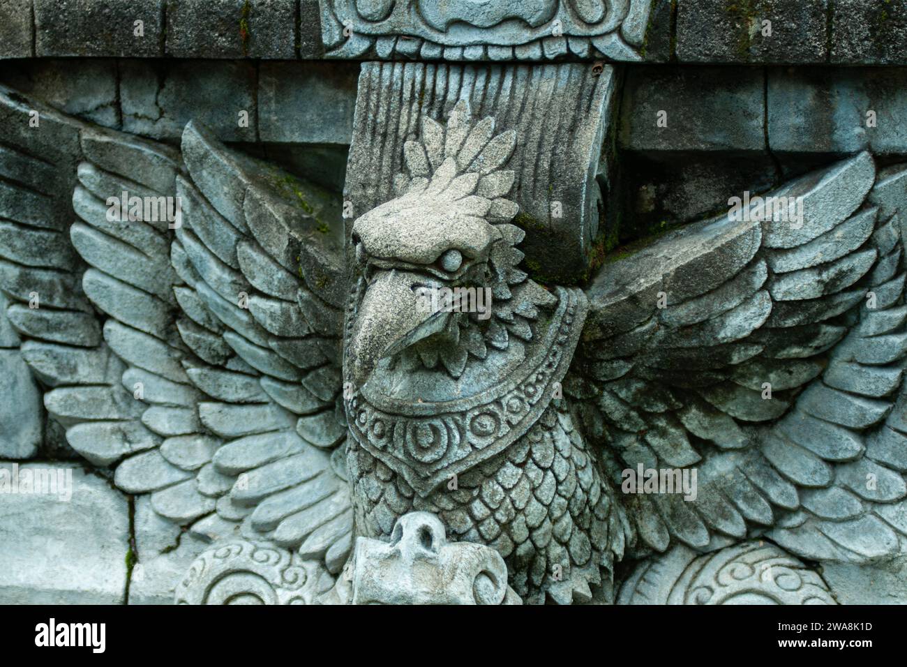 a stone carving on a wall in the form of a statue of an eagle Stock Photo