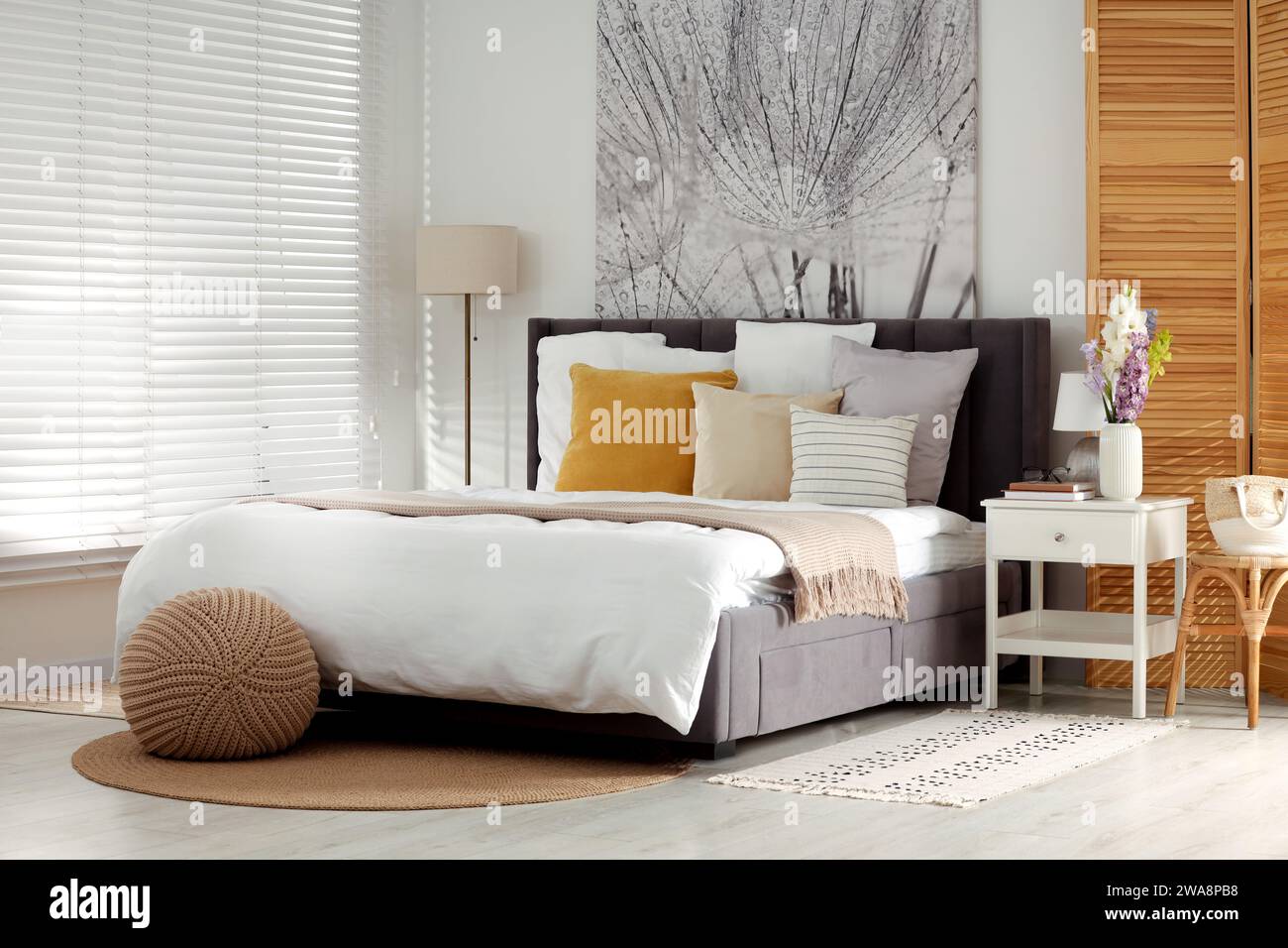 Light bedroom interior with comfortable bed and beautiful picture Stock ...