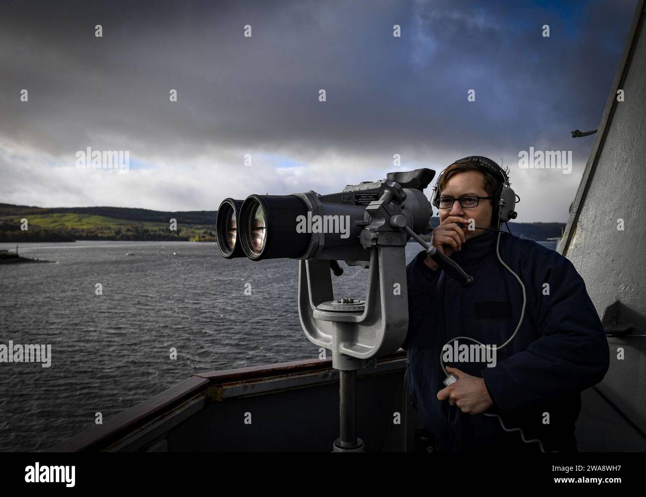US military forces. 171022UY653-009  FASLANE, United Kingdom (Oct. 22, 2017) Operations Specialist 2nd Class Jonathan Materni stands a port lookout watch aboard the Arleigh Burke-class guided-missile destroyer USS Oscar Austin (DDG 79) Oct. 22, 2017. Oscar Austin is on a routine deployment supporting U.S. national security interests in Europe, and increasing theater security cooperation and forward naval presence in the U.S. 6th Fleet area of operations. (U.S. Navy photo by Mass Communication Specialist 2nd Class Ryan Utah Kledzik/Released) Stock Photo