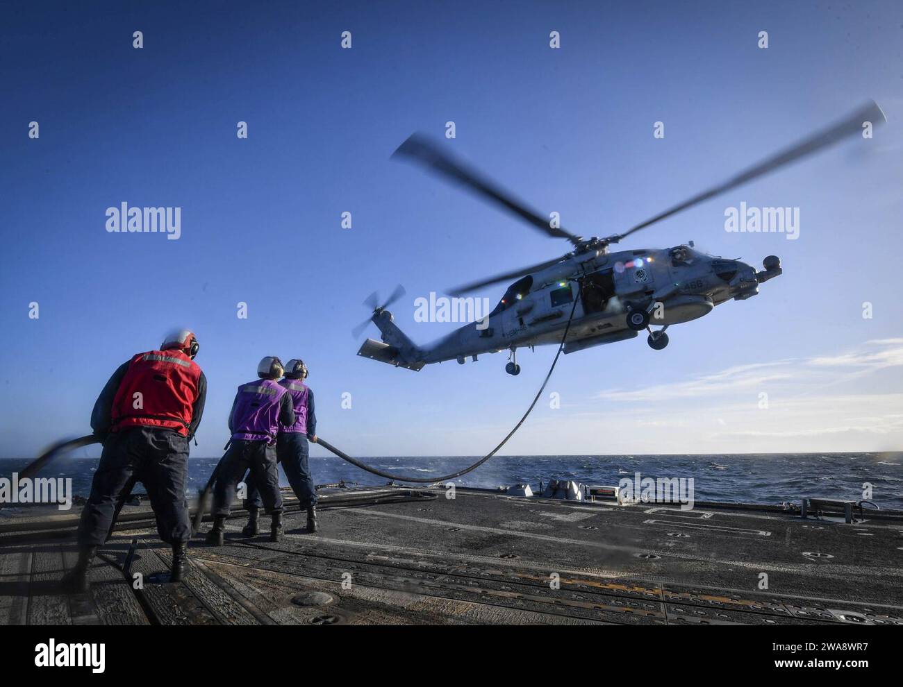 US military forces. 171025UY653-508  ATLANTIC OCEAN (Oct. 25, 2017) Sailors refuel an MH-60R Sea Hawk helicopter, attached to the 'Grandmasters' of Helicopter Maritime Strike Squadron (HSM) 46, on the flight deck of the Arleigh Burke-class guided-missile destroyer USS Oscar Austin (DDG 79) Oct. 25, 2017. Oscar Austin is on a routine deployment supporting U.S. national security interests in Europe, and increasing theater security cooperation and forward naval presence in the U.S. 6th Fleet area of operations. (U.S. Navy photo by Mass Communication Specialist 2nd Class Ryan Utah Kledzik/Released Stock Photo