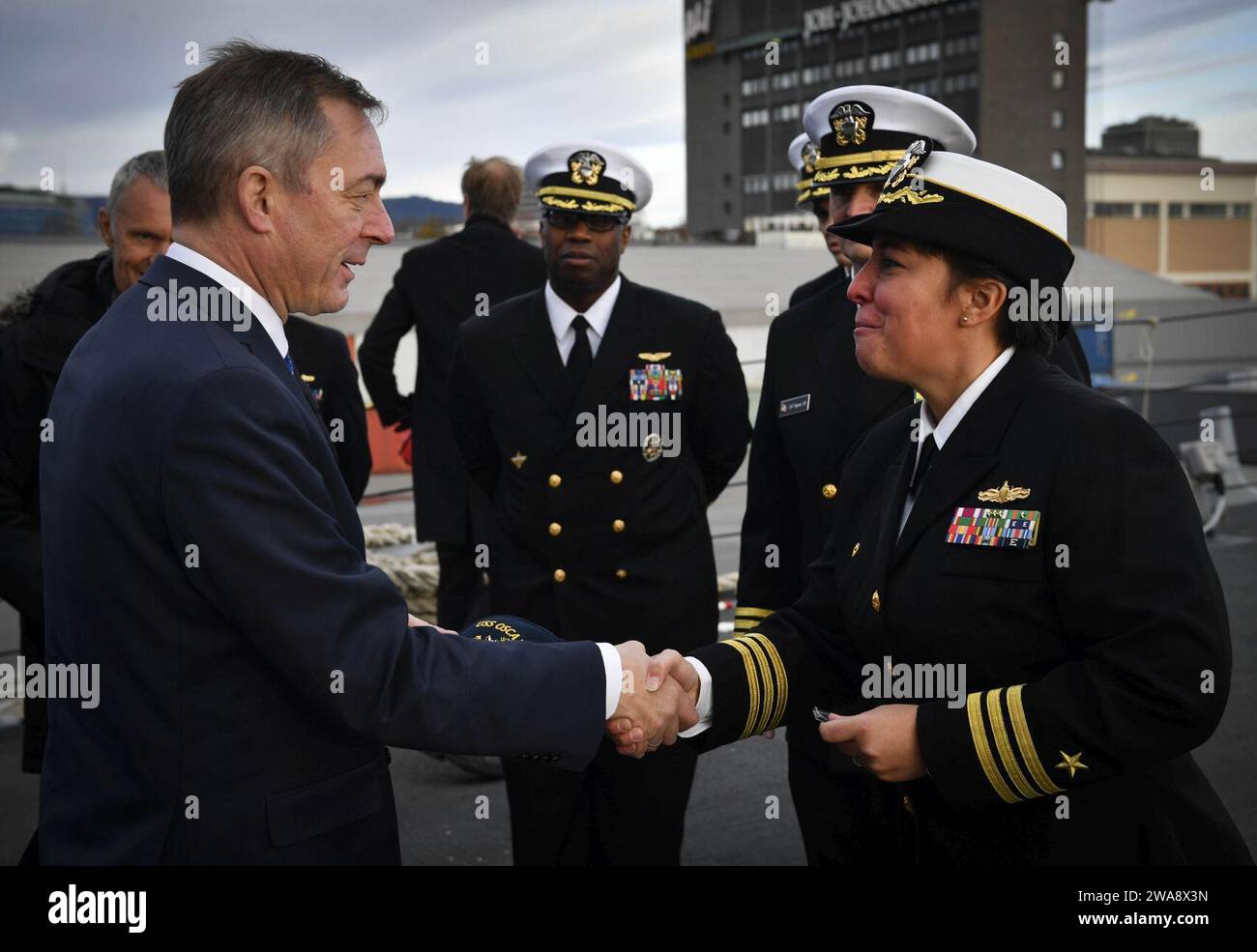 US military forces. 171030UY653-073  OSLO, Norway (Oct. 30, 2017) Cmdr. Samantha Dutily,  commanding officer of the Arleigh Burke-class guided-missile destroyer USS Oscar Austin (DDG 79), shakes hands with Norwegian Defense Minister Frank Bakke-Jensen  Oct. 30, 2017. Oscar Austin is on a routine deployment supporting U.S. national security interests in Europe, and increasing theater security cooperation and forward naval presence in the U.S. 6th Fleet area of operations. (U.S. Navy photo by Mass Communication Specialist 2nd Class Ryan Utah Kledzik/Released) Stock Photo