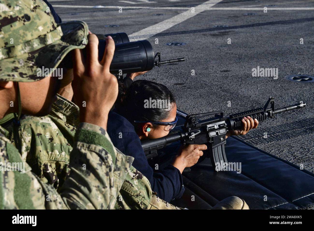 US military forces. 171108BK384-219 MEDITERRANEAN SEA (Nov. 8, 2017) Seaman Joanna Valdez, from Fontana, California, and assigned to the deck department aboard the San Antonio-class amphibious transport dock ship USS San Diego (LPD 22), fires an M4A1 Carbine during a live-fire training exercise on the ship’s flight deck Nov. 8, 2017. San Diego is deployed with the America Amphibious Ready Group and the 15th Marine Expeditionary Unit to support maritime security and theater security cooperation in efforts in the U.S. 6th Fleet area of operations. (U.S. Navy photo by Mass Communication Specialis Stock Photo