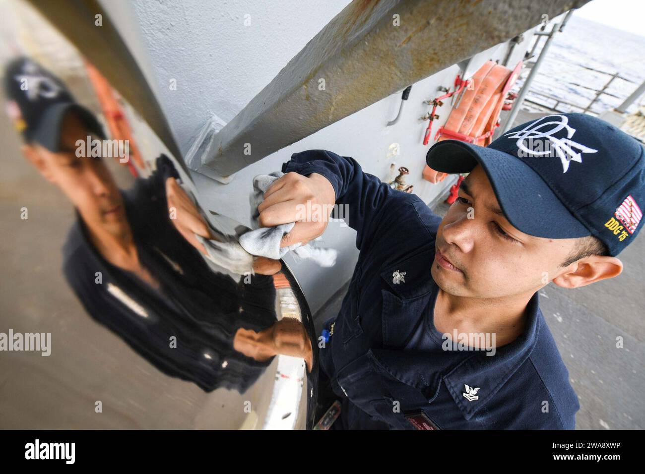 US military forces. 171113FP878-001 MEDITERRANEAN SEA (Nov. 13, 2017) Culinary Specialist 2nd Class Julian Fuenzalida, from Virginia Beach, Virginia, polishes the ship’s bell aboard the Arleigh Burke-class guided-missile destroyer USS Donald Cook (DDG 75) during exercise Dogu Akdeniz 2017, Nov. 13. Dogu Akdeniz is a Turkish-led, multinational maritime exercise designed to improve combined combat capabilities, increase operational capacity and strengthen relationships among NATO allies. (U.S. Navy photo by Mass Communication Specialist 1st Class Theron J. Godbold /Released) Stock Photo