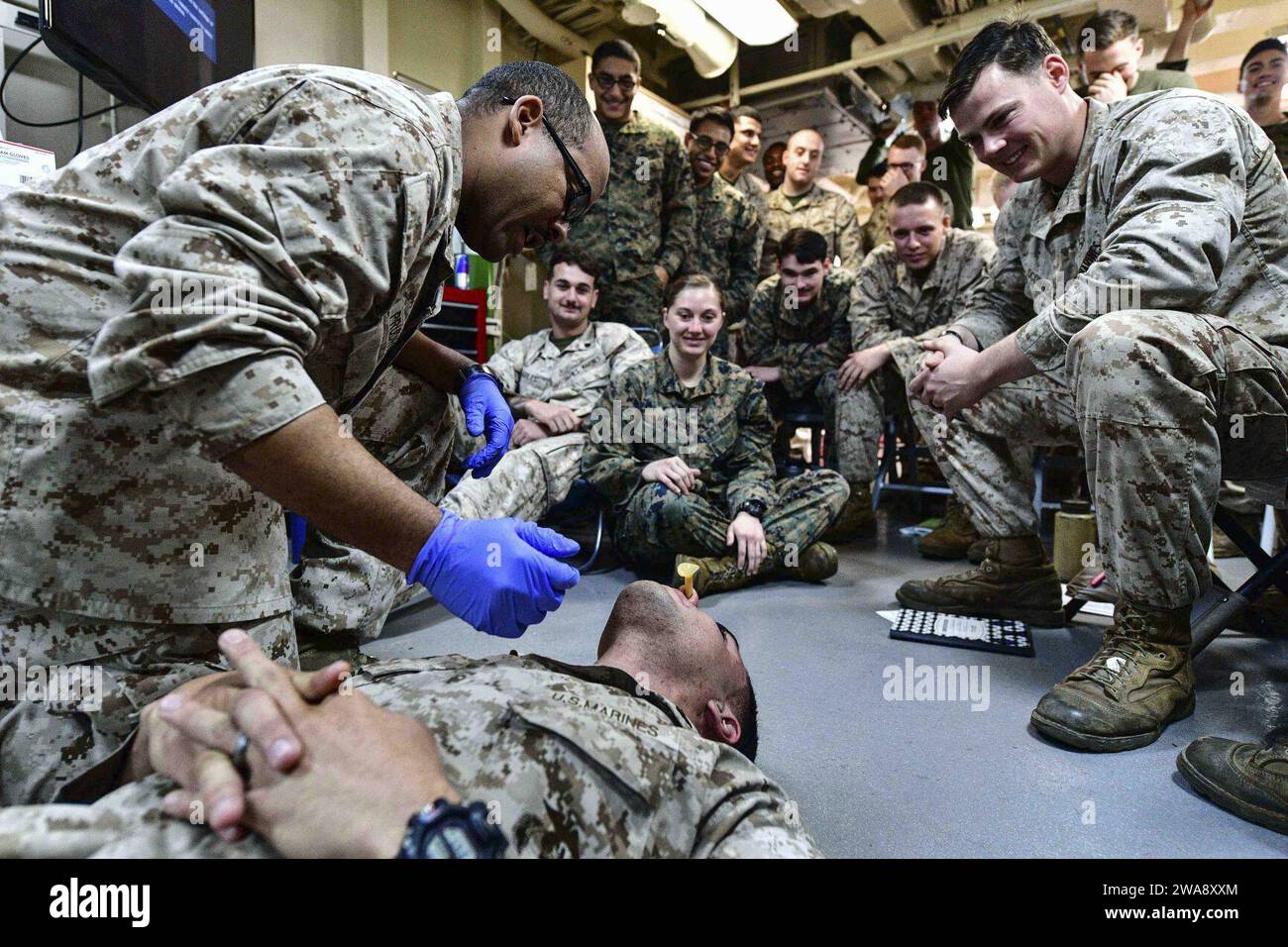 US military forces. 171114BK384-037 MEDITERRANEAN SEA (Nov. 14, 2017) Hospital Corpsman 2nd Class Woodrow Prudhomme, from Kinder, Louisiana, demonstrates proper nasal pharyngeal airway insertion during a tactical combat casualty care course in a medical operating room aboard the San Antonio-class amphibious transport dock ship USS San Diego (LPD 22) Nov. 14, 2017. San Diego is deployed with the America Amphibious Ready Group and the 15th Marine Expeditionary Unit to support maritime security and theater security cooperation in efforts in the U.S. 6th Fleet area of operations. (U.S. Navy photo Stock Photo