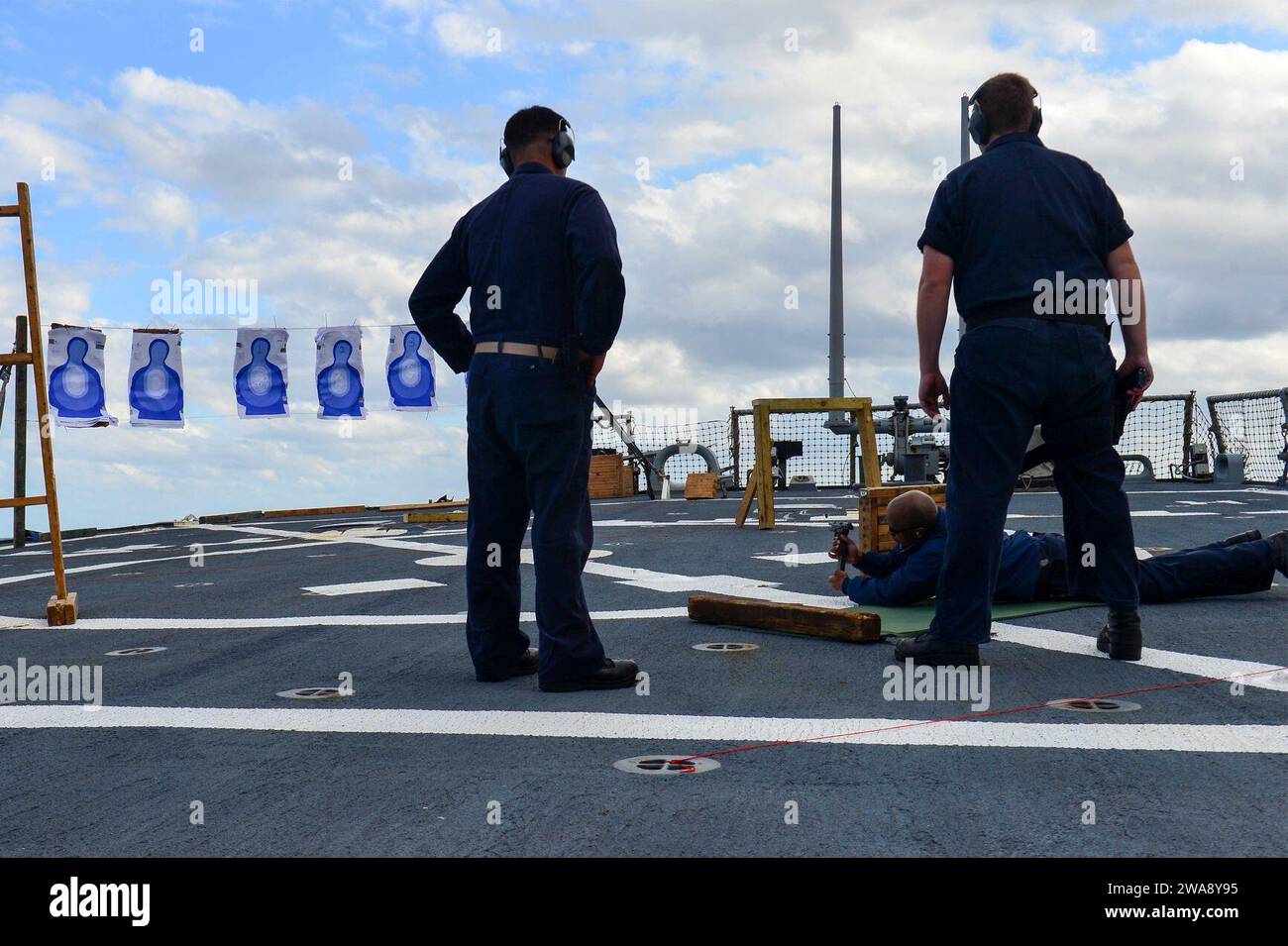 US military forces. 171128QR145-046 MEDITERRANEAN SEA (Nov. 28, 2017)  Operations Specialist 1st Class Fruquann Powers,  reloads an M9 pistol while Senior Chief Machinist's Mate Jonathan Sarmiento, left, and Fire Controlman 2nd Class Lucas Halter supervise during small-arms training aboard the Arleigh Burke-class guided-missile destroyer USS Porter (DDG 78) Nov. 28, 2017. Porter, forward-deployed to Rota, Spain, is on its fourth patrol in the U.S. 6th Fleet area of operations in support of regional allies and partners, and U.S. national security interests in Europe. (U.S. Navy photo by Mass Co Stock Photo