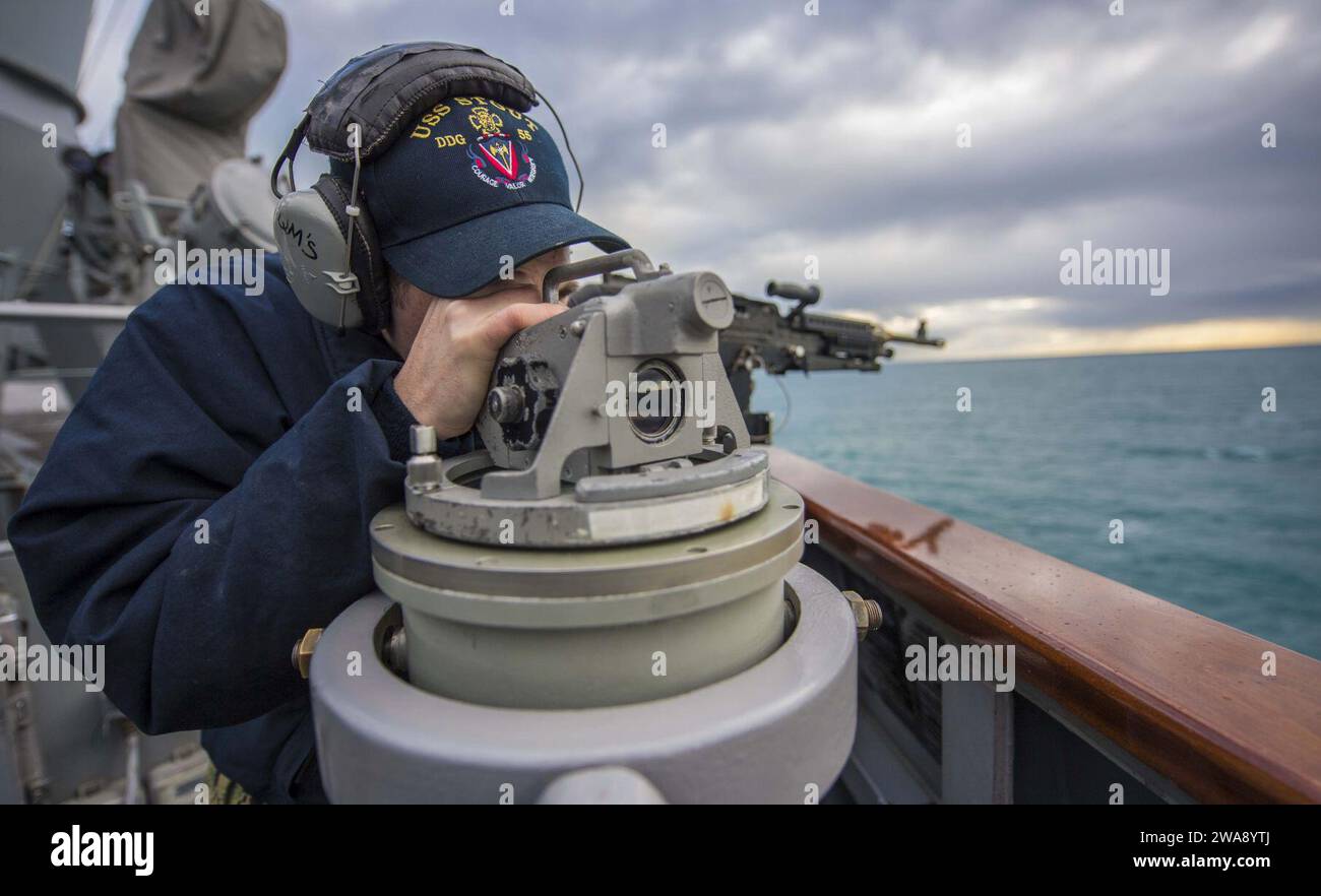 US military forces. 171230KA046-0180  BRINDISI, Italy (Dec. 30, 2017) – Quartermaster 2nd Class Anthony Mcclure looks through an alidade aboard the Arleigh Burke-class guided-missile destroyer USS Carney (DDG 64), as the ship prepares to moor in Brindisi, Italy, Dec. 30, 2017. Carney, forward-deployed to Rota, Spain, is on its fourth patrol in the U.S. 6th Fleet area of operations in support of regional allies and partners, and U.S. national security interests in Europe. (U.S. Navy photo by Mass Communication Specialist 2nd Class James R. Turner/Released) Stock Photo