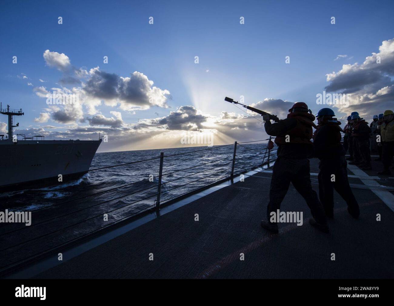 US military forces. 180103KA046-0140  AEGEAN SEA (Jan. 3, 2018) – Sailors aboard the Arleigh Burke-class guided-missile destroyer USS Carney (DDG 64) prepare to send shot lines to the fleet replenishment oiler USNS Patuxent (T-AO 201) during a replenishment-at-sea, Jan. 3, 2018. Carney, forward-deployed to Rota, Spain, is on its fourth patrol in the U.S. 6th Fleet area of operations in support of regional allies and partners, and U.S. national security interests in Europe. (U.S. Navy photo by Mass Communication Specialist 2nd Class James R. Turner/Released) Stock Photo