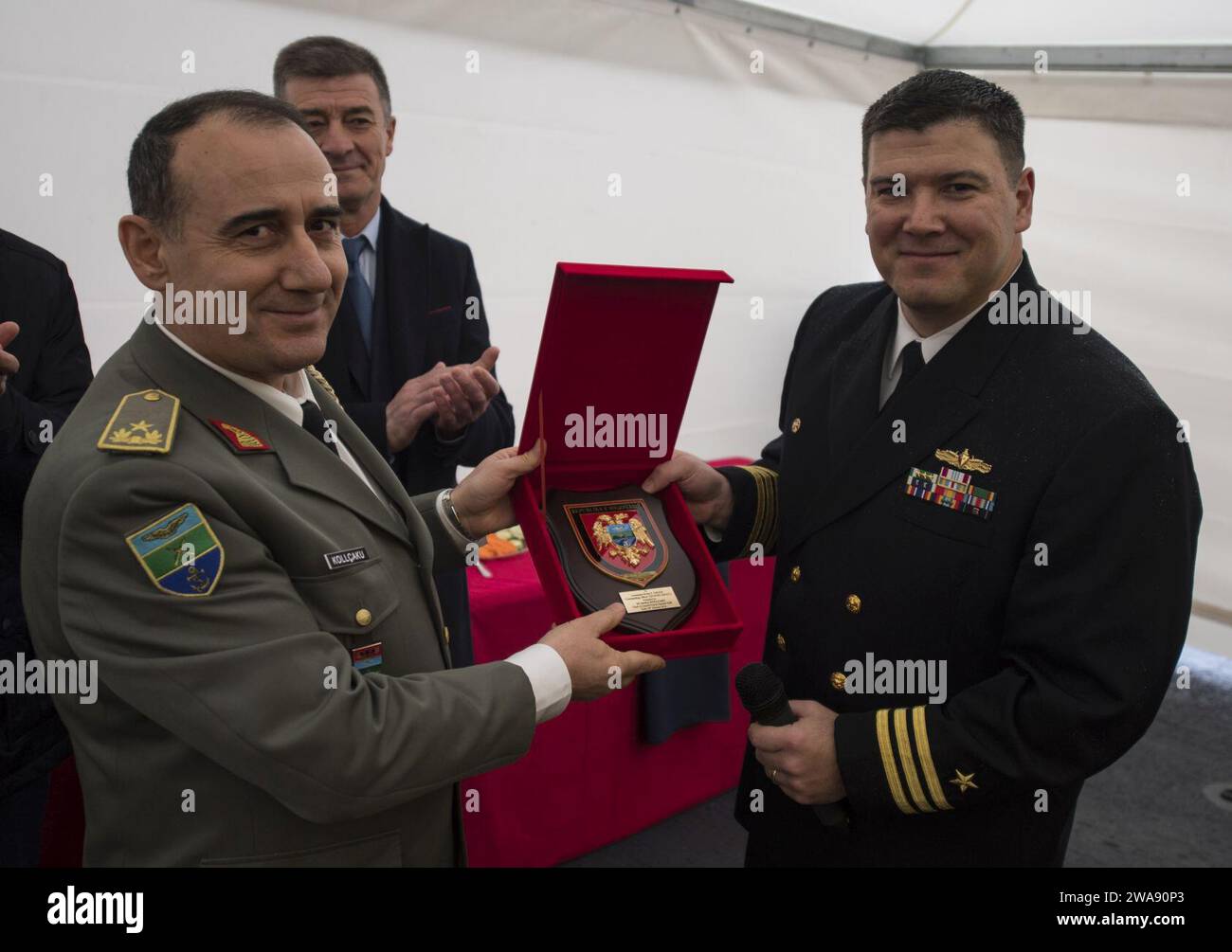 US military forces. 180210RG482-598  VLORE, Albania (Feb. 10, 2018) Republic of Albania Chief of Defense Major General Bardhyl Kollcku, left, presents Cmdr. Bryan S. Gallo, commanding officer of the Arleigh Burke-class, guided-missile destroyer USS Ross (DDG 71), with a Republic of Albania crest during a reception held aboard ross for high-ranking officials from the Republic of Albania and the United States in Vlore, Albania, Feb. 10, 2018. Ross, forward-deployed to Rota, Spain, is on its sixth patrol in the U.S. 6th Fleet area of operations in support of regional allies and partners and U.S. Stock Photo