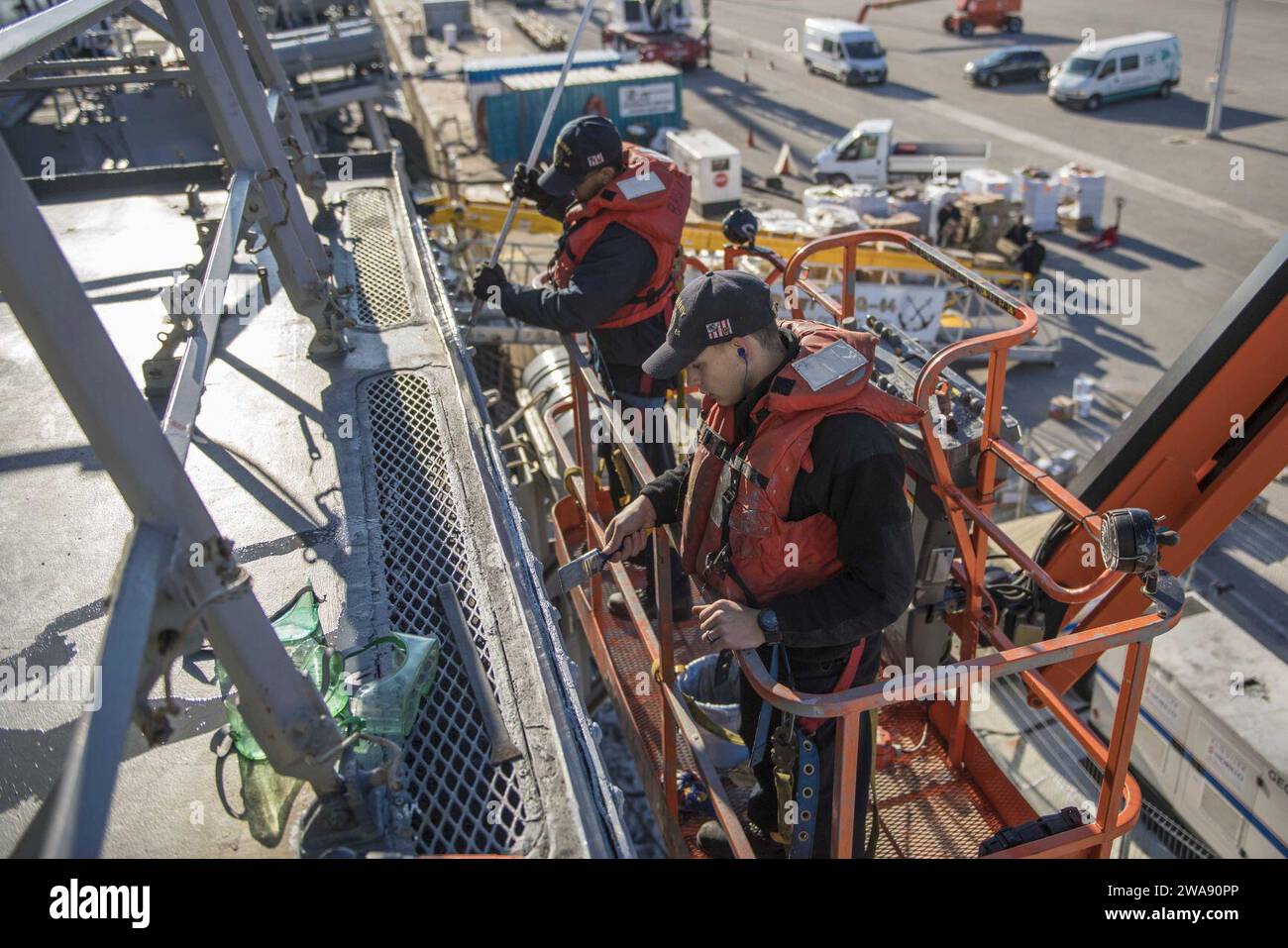 US military forces. NAVAL STATION ROTA, Spain (Feb. 08, 2018) Р Seaman Brinio Urena, left, and Gas Turbine System Technician Mechanical Fireman Kyle Ribble paint over the side of the Arleigh Burke-class guided-missile destroyer USS Carney (DDG 64), in Rota, Spain, Feb. 8, 2018. Carney, forward-deployed to Rota, Spain, is on its fourth patrol in the U.S. 6th Fleet area of operations in support of regional allies and partners, and U.S. national security interests in Europe. (U.S. Navy photo by Mass Communication Specialist 2nd Class James R. Turner/Released) Stock Photo