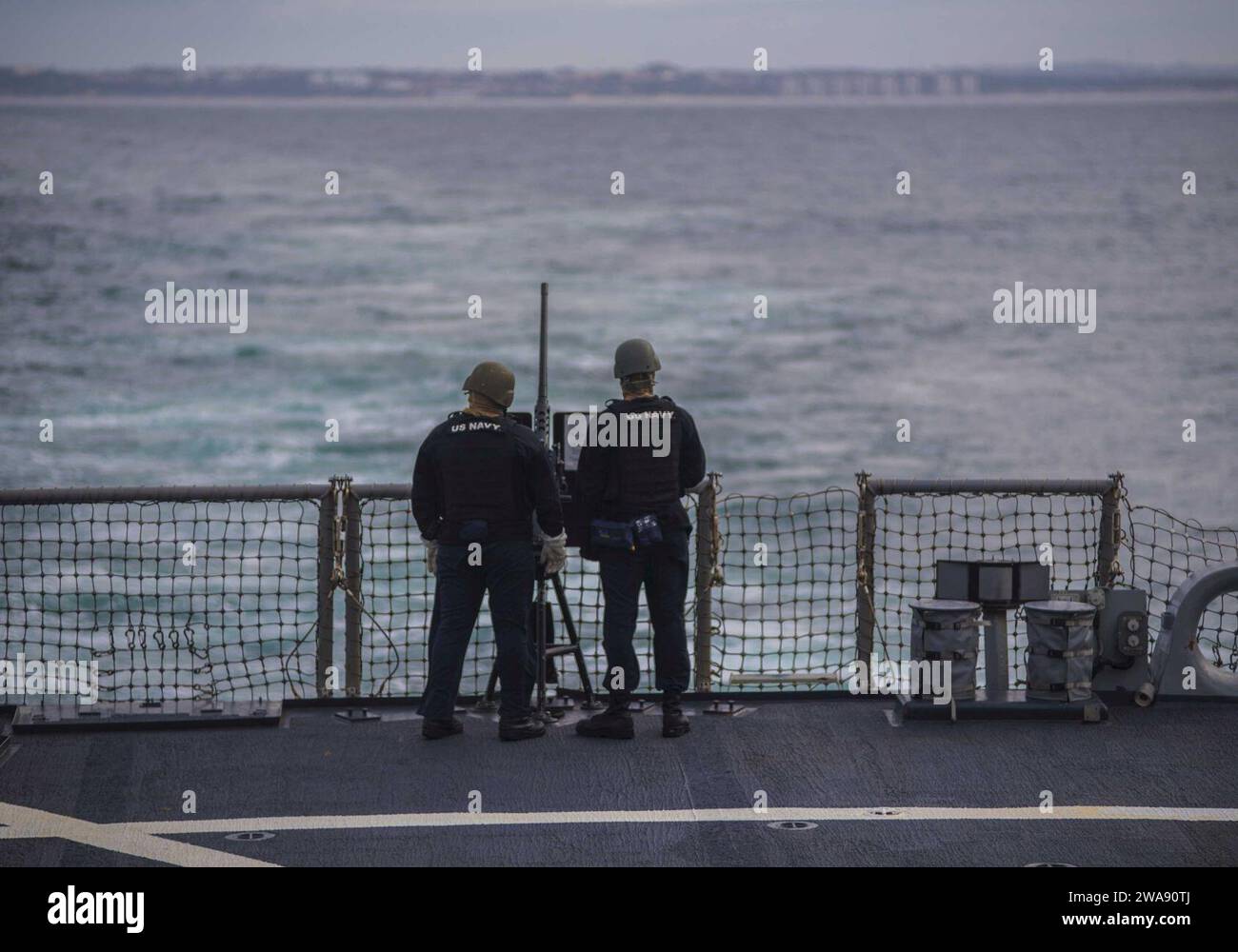 US military forces. 180212KA046-0075  NAVAL STATION ROTA, Spain (Feb. 12, 2018) Р Ship's Serviceman 1st Class Isaac Payne, left, and Logistic's Specialist Seaman Darnell Thomas man a .50 caliber machine gun aboard the Arleigh Burke-class guided-missile destroyer USS Carney (DDG 64), while departing Rota, Spain, Feb. 12, 2018. Carney, forward-deployed to Rota, Spain, is on its fourth patrol in the U.S. 6th Fleet area of operations in support of regional allies and partners, and U.S. national security interests in Europe. (U.S. Navy photo by Mass Communication Specialist 2nd Class James R. Turne Stock Photo