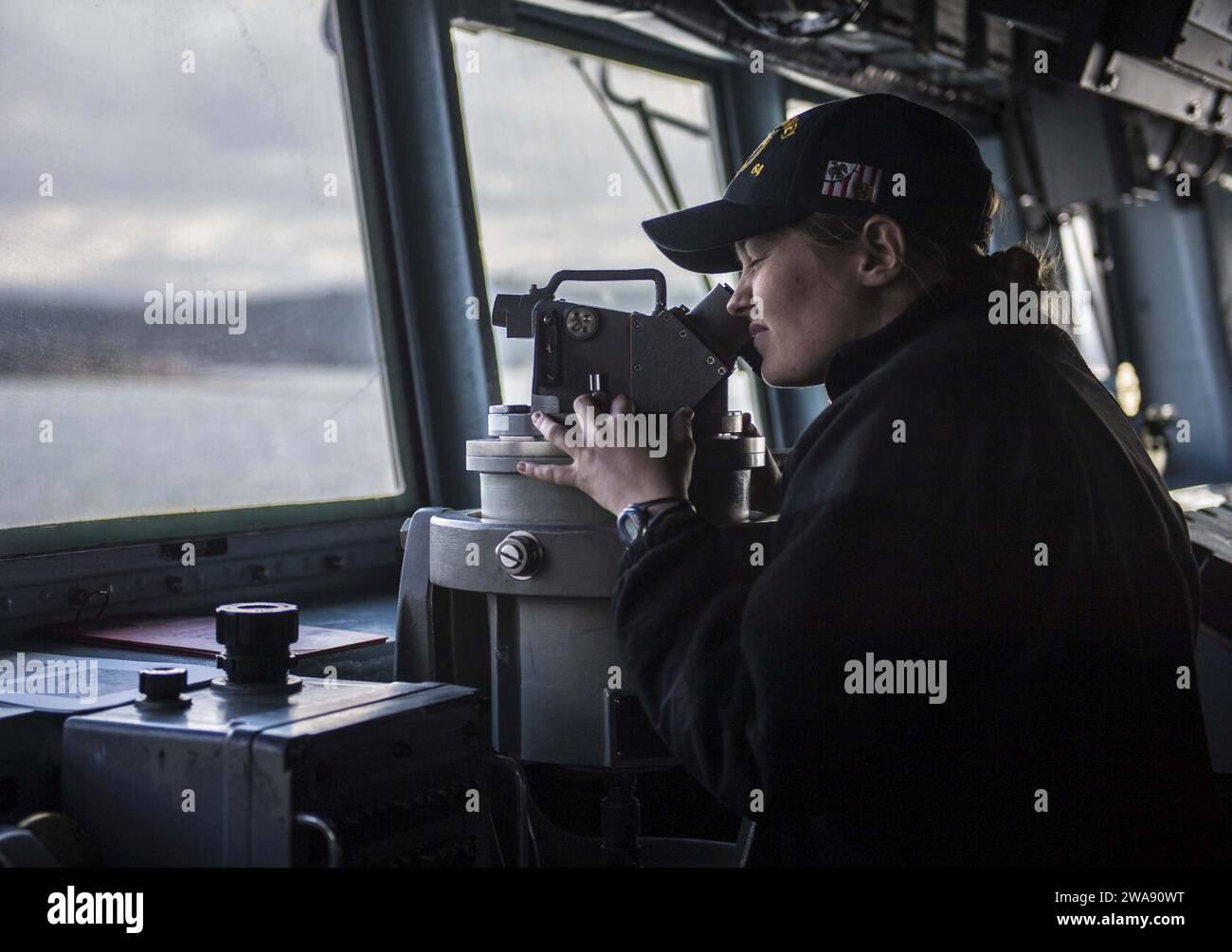 US military forces. 180217KA046-0084  DARDANELLES STRAIT (Feb. 17, 2018) Р Ensign Bridget Kennedy uses a telescopic alidade during watch on the bridge aboard the Arleigh Burke-class guided-missile destroyer USS Carney (DDG 64), as the ship transits the Dardanelles Straits, Feb, 17, 2018. Carney, forward-deployed to Rota, Spain, is on its fourth patrol in the U.S. 6th Fleet area of operations in support of regional allies and partners, and U.S. national security interests in Europe. (U.S. Navy photo by Mass Communication Specialist 2nd Class James R. Turner/Released) Stock Photo