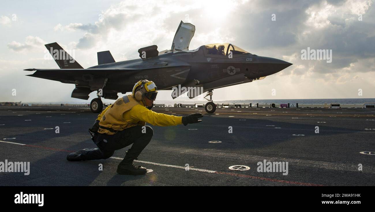 US military forces. 180309BD308-2019  EAST CHINA SEA (Mar. 9, 2018) Aviation Boatswain's Mate 3rd Class Donovan Hampton launches an F-35B off the flight deck of the amphibious assault ship USS Wasp (LHD 1) as part of a routine patrol in the Indo-Pacific region. Pilots with the 'Green Knights' of Marine Fighter Attack Squadron 121 (VMFA-121), assigned under the Okinawa-based 31st Marine Expeditionary Unit, are scheduled to conduct a series of qualification flights on Wasp over a multi-day period. The Wasp Expeditionary Strike Group is conducting a regional patrol meant to strengthen regional al Stock Photo