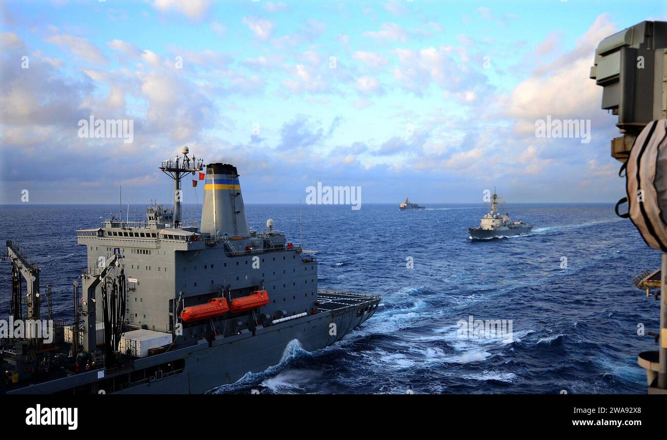 US military forces. 180329RI884-0179  PHILIPPINE SEA (March 29, 2018) The amphibious dock landing ship USS Ashland (LSD 48), background, the Arleigh Burke-class guided-missile destroyer USS Dewey (DDG 105), and the amphibious assault ship USS Wasp (LHD 1), not pictured, prepare for a replenishment at sea with the fleet replenishment oiler USNS Tippecanoe (T-AO 199), left. Wasp and Dewey, part of the Wasp Expeditionary Strike Group, with embarked 31st Marine Expeditionary Unit (31st MEU), are operating in the Indo-Pacific region to enhance interoperability with partners, serve as a ready-respon Stock Photo