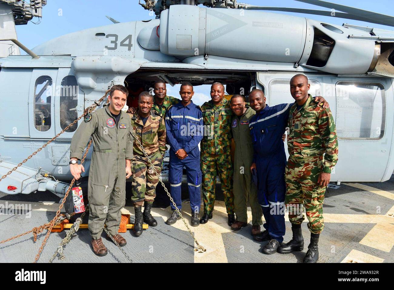 US military forces. 180331QR145-028 MEDITERRANEAN SEA (March 31, 2018) Sailors assigned to Helicopter Sea Combat Squadron (HSC) 28 and sailors from Cote d'Ivoire, Gabon, and Nigeria pose for a photo in front of an MH-60S Sea Hawk helicopter aboard the Blue Ridge-class command and control ship USS Mount Whitney (LCC 20) March 31, 2018. Mount Whitney, forward-deployed to Gaeta, Italy, operates with a combined crew of U.S. Navy Sailors and Military Sealift Command civil service mariners. (U.S. Navy photo by Mass Communication Specialist 3rd Class Krystina Coffey/Released) Stock Photo