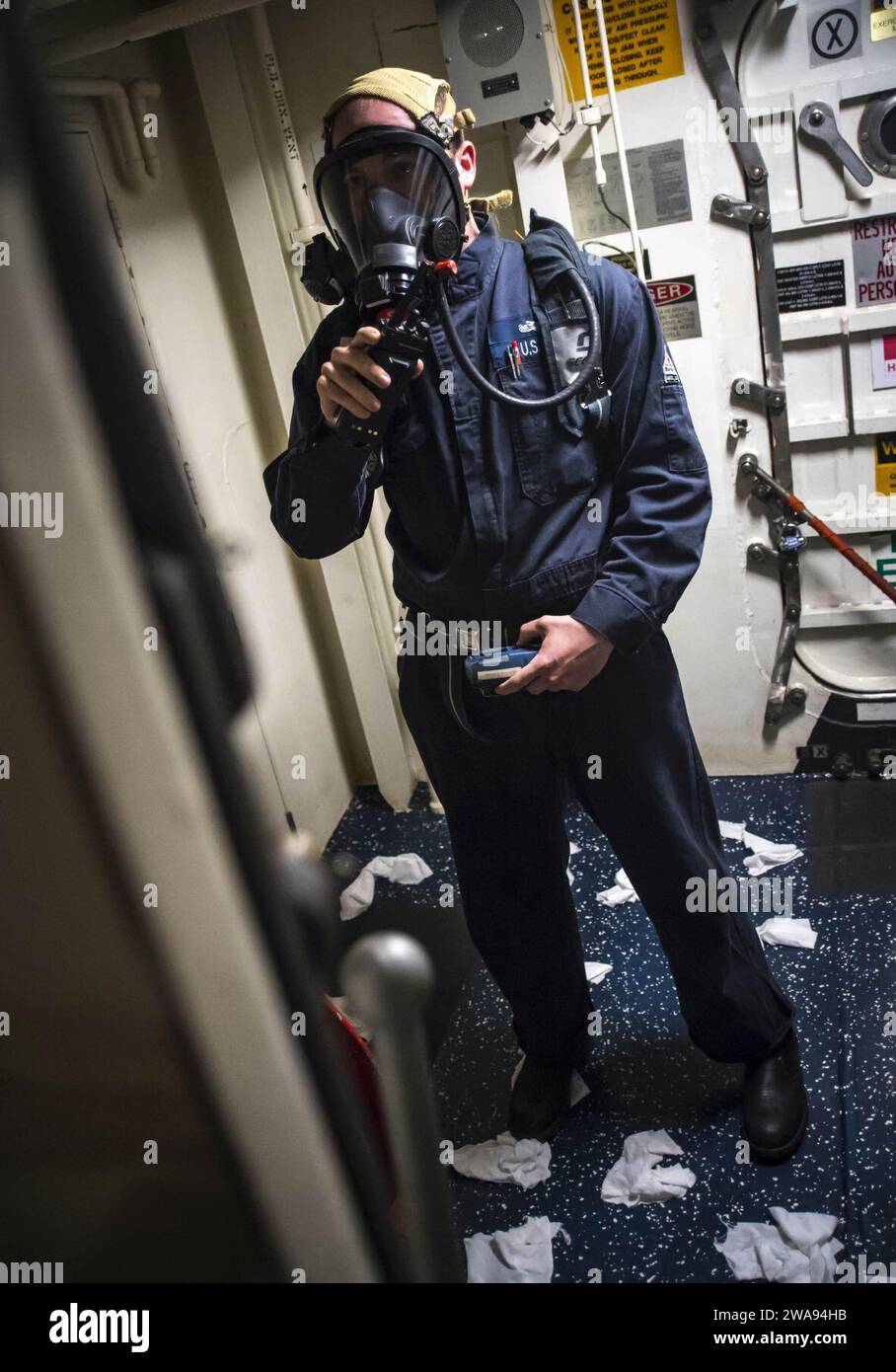 US military forces. 180426RG482-152 THE MINCH (April 26, 2018) Damage Controlman 2nd Class Frederick Jensen reports the status of a simulated toxic gas leak during a 'flying squad' drill aboard the Arleigh Burke-class guided-missile destroyer USS Ross (DDG 71) April 26, 2018. The ship's flying squad is a group of highly-trained first responders to emergencies such as fires and flooding. Ross is participating in Joint Warrior 18-1, a U.K.-led, multinational exercise that exercises interoperability and cooperation in all applicable warfare areas. (U.S. Navy photo by Mass Communication Specialist Stock Photo