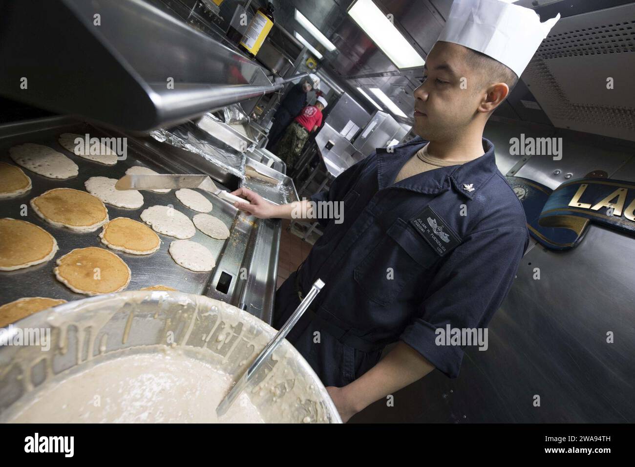 US military forces. 180429KP946-0026 MEDITERRANEAN SEA  (April 29, 2018) Culinary Specialist 2nd Class Julian Fuenzalida, from Houston, prepares pancakes aboard the Arleigh Burke-class guided-missile destroyer USS Donald Cook (DDG 75) April 29, 2018.  Donald Cook, forward-deployed to Rota, Spain, is on its seventh patrol in the U.S. 6th Fleet area of operations in support of regional allies and partners, and U.S. national security interests in Europe and Africa. (U.S. Navy photo by Mass Communication Specialist 2nd Class Alyssa Weeks / Released) Stock Photo