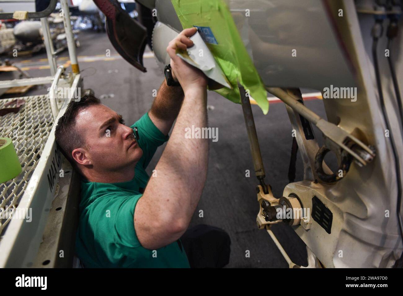 US military forces. 180518DZ642-0021 MEDITERRANEAN SEA (May 18, 2018) Aviation Structural Mechanic 1st Class Clinton Ramisiare, assigned to the 'Seahawks' of Carrier Airborne Early Warning Squadron (VAW) 126, prepares to paint an E-2D Hawkeye in the hangar bay aboard the Nimitz-class aircraft carrier USS Harry S. Truman (CVN 75). As the Carrier Strike Group 8 flag ship, Truman's support of Operation Inherent Resolve demonstrates the capability and flexibility of U.S. Naval Forces, and its resolve to eliminate the terrorist group ISIS and the threat it poses. (U.S. Navy photo by Mass Communicat Stock Photo