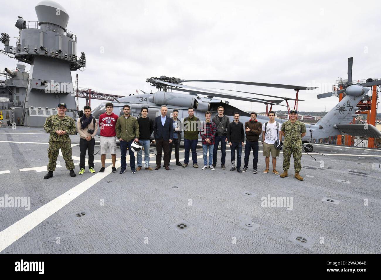 US military forces. 180522XT273-266 LISBON, Portugal (May 22, 2018) Electronic's Technician 2nd Class Petty Officer Gavin Beaver and Information Systems Technician 2nd Class Petty Officer Myles Brinkley pose for a group photo with Portuguese engineering students during a community relations tour aboard the U.S. 6th Fleet command and control ship USS Mount Whitney (LCC 20) in Lisbon, Portugal, May 22, 2018. Mount Whitney, the U.S. 6th Fleet flagship, operates with a combined crew of U.S. Navy Sailors and Military Sealift Command civil service mariners.(U.S. Navy photo by Mass Communication Spec Stock Photo