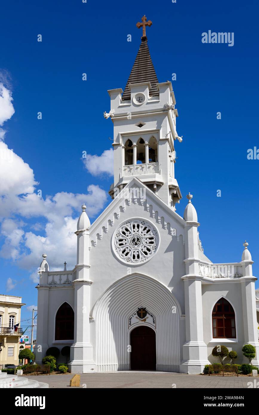 White church with bell tower and Gothic architecture under a clear blue sky, Church of San Pedro Apostol, Catedral San Pedro Apóstol, San Pedro de Mac Stock Photo