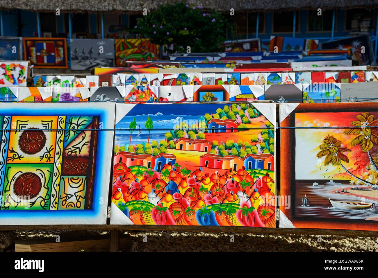 Art stall with paintings depicting tropical landscapes and seascapes, market, Bayahibe, Dominican Republic, Hispaniola, Caribbean, Central America Stock Photo