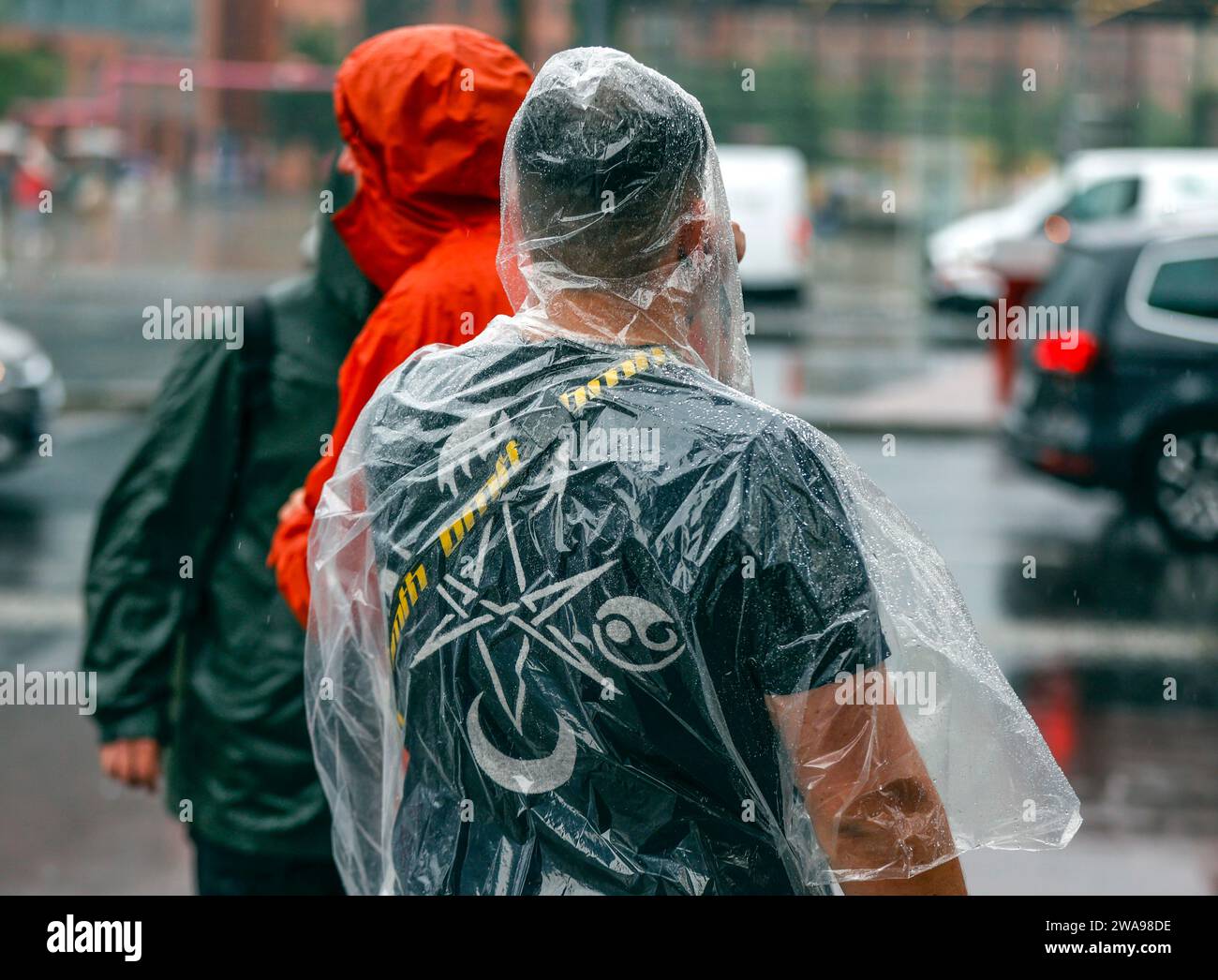 Tourists with rain capes and umbrellas during heavy rainfall, 23.06.2023 Stock Photo