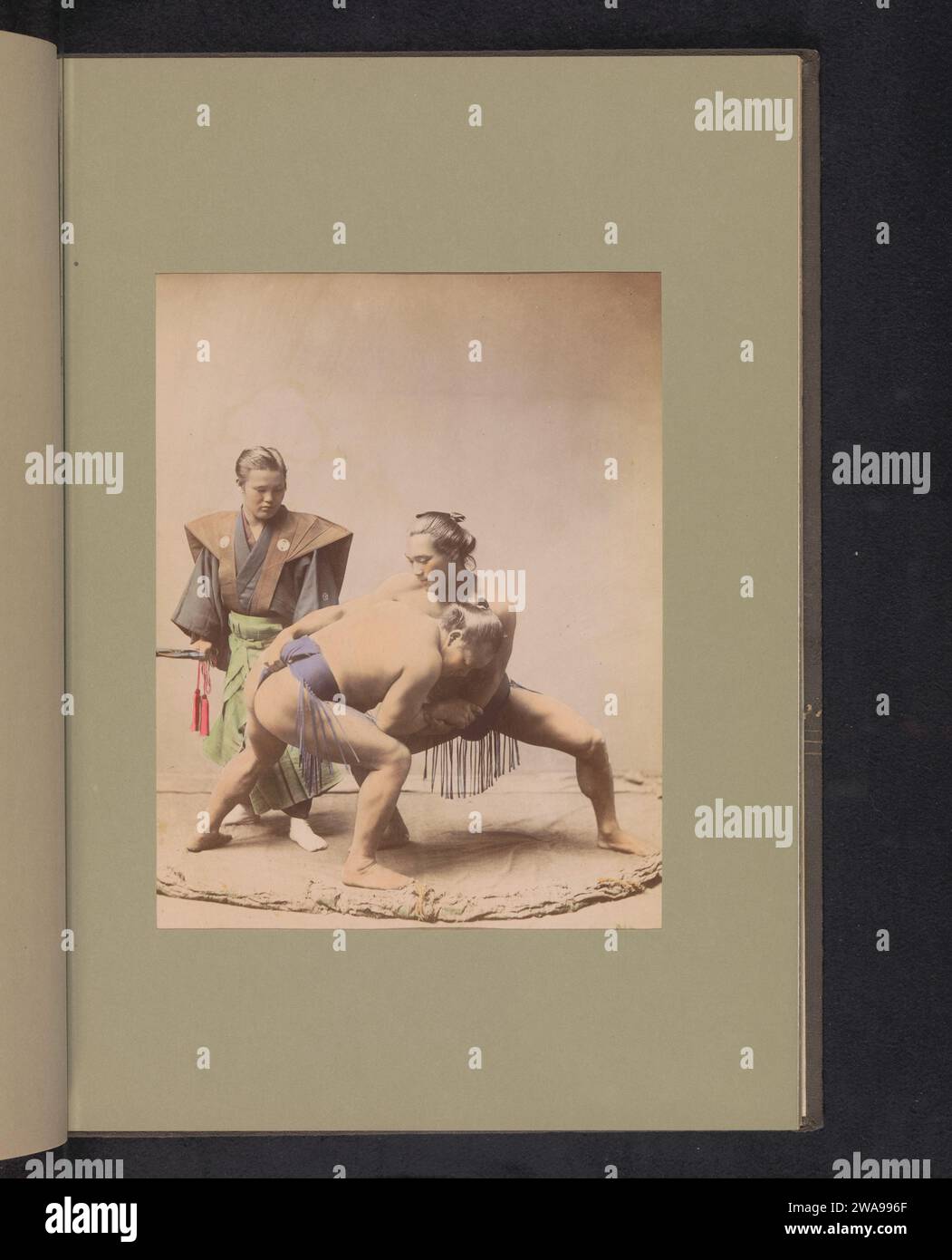 Two sumo wrestlers and a referee, c. 1887 - in or before 1897 photograph  Yokohamajapan photographic support albumen print wrestling (sport) (+ the contest (sports, games, etc.)). wrestling (sport) (+ judge, umpire, referee (sports, games, etc.)) Stock Photo