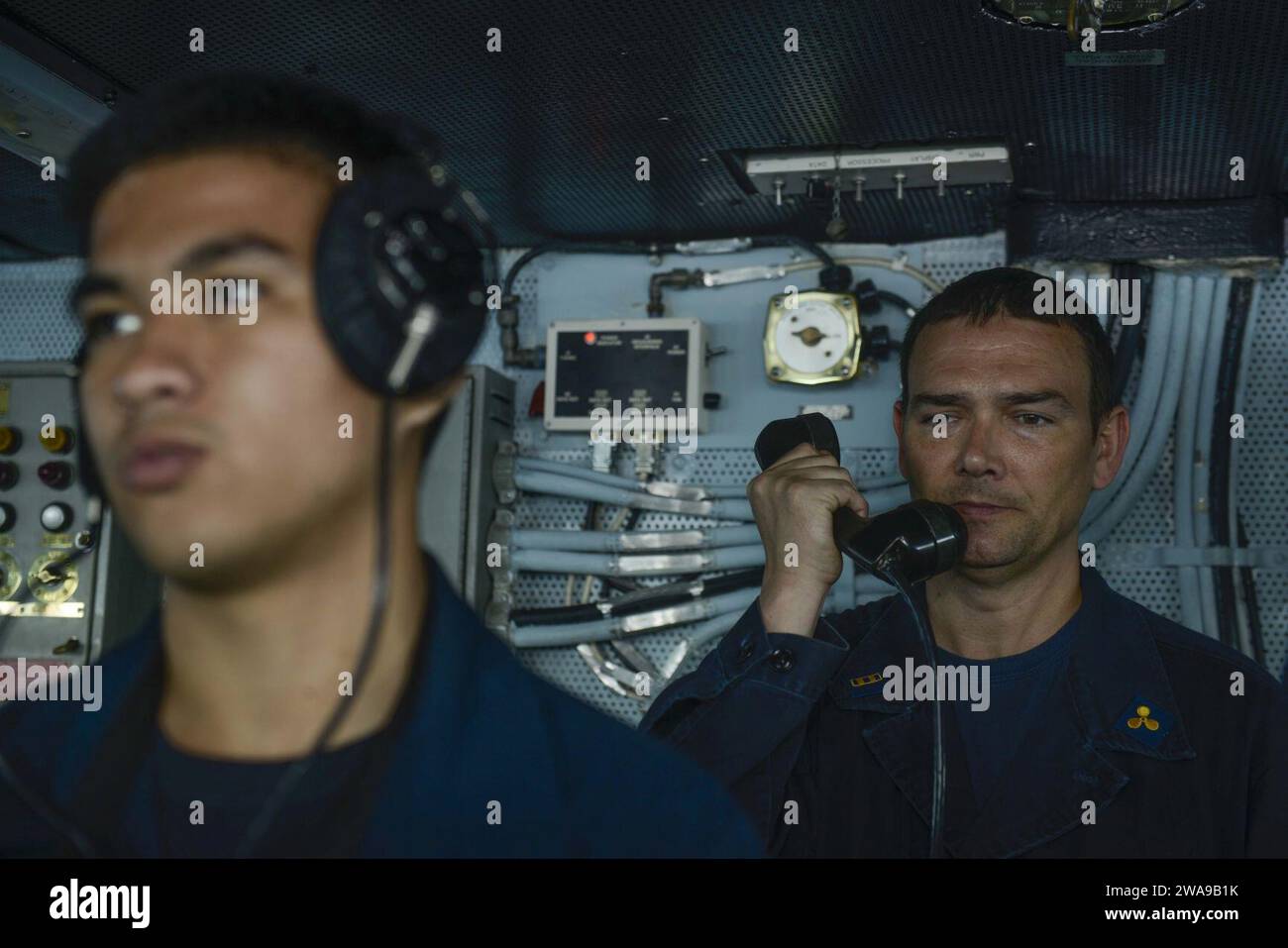 US military forces. 180608MK318-0236 MEDITERRANEAN SEA (Jun 8, 2018) Chief Warrant Officer 2 Tim Johnson relays orders on the bridge during a replenishment-at-sea between the Nimitz-class aircraft carrier USS Harry S. Truman and the USNS Arctic (T-AOE 8). Harry S.Truman is currently operating in U.S. 6th Fleet area of responsibility in support of maritime security operations alongside allies. (U.S. Navy photo by Mass Communication Specialist 3rd Class Victoria Granado/Released) Stock Photo