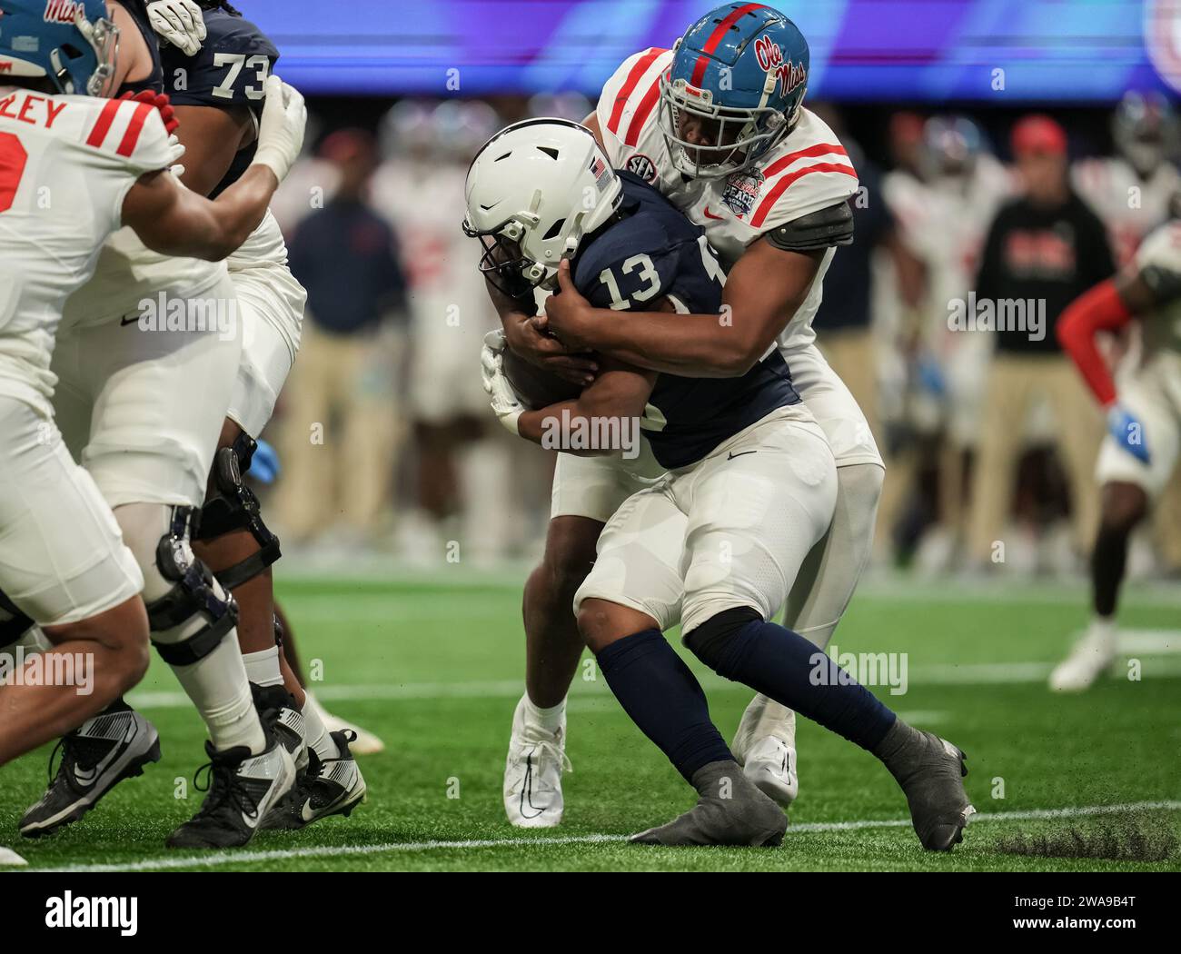 Penn State Nittany Lions running back Kaytron Allen (13) runs up the field as the Mississippi Rebels defense tackles him Chick-fil-A Peach Bowl college Football game between Pen state vs  Mississippi Rebels at Mercedes-Benz Stadium on January 1st, 2023 in Atlanta, Georgia. Mississippi Rebels beat Pen state 38-25 (David Venezia / Image of Sport) Stock Photo