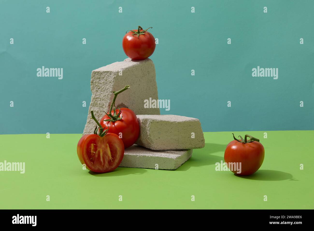 Red tomatoes and some blocks of stones displayed for healthy concept