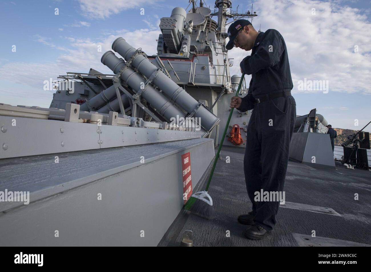 US military forces. 180616KP946-0003 MINORCA, Spain (June 16, 2018) Fire Controlman (Aegis) 2nd Class Nathan, Wickenkamp, from Portales, New Mexico, sweeps the deck aboard the Arleigh Burke-class guided-missile destroyer USS Donald Cook (DDG 75) June 16, 2018. Donald Cook, forward-deployed to Rota, Spain, is on its seventh patrol in the U.S. 6th Fleet area of operations in support of regional allies and partners, and U.S. national security interests in Europe and Africa. (U.S. Navy photo by Mass Communication Specialist 2nd Class Alyssa Weeks / Released) Stock Photo