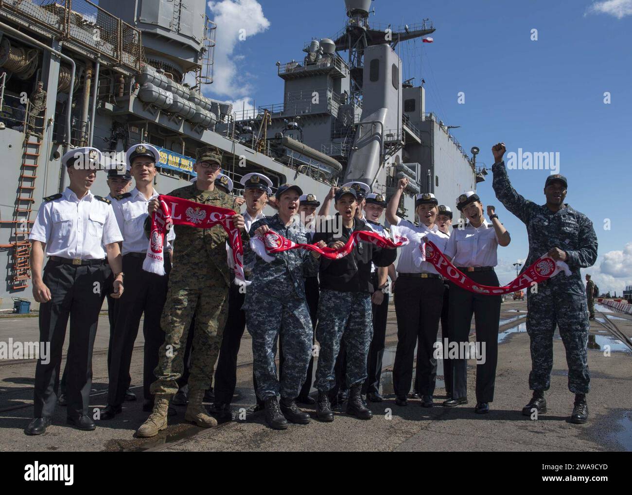 US military forces. 180623TJ319-0035 GDYNIA, Poland (June 23, 2018) Sailors and Marines assigned to the Harpers Ferry-class dock landing ship USS Oak Hill (LSD 51) and the 26th Marine Expeditionary Unit and students from the Polish Naval Academy cheer for the Poland national football team before touring the ship, June 23, 2018. Oak Hill, homeported in Virginia Beach, Virginia, is conducting naval operations in the U.S. 6th Fleet area of operations. (U.S. Navy photo by Mass Communication Specialist 3rd Class Jessica L. Dowell/Released) Stock Photo